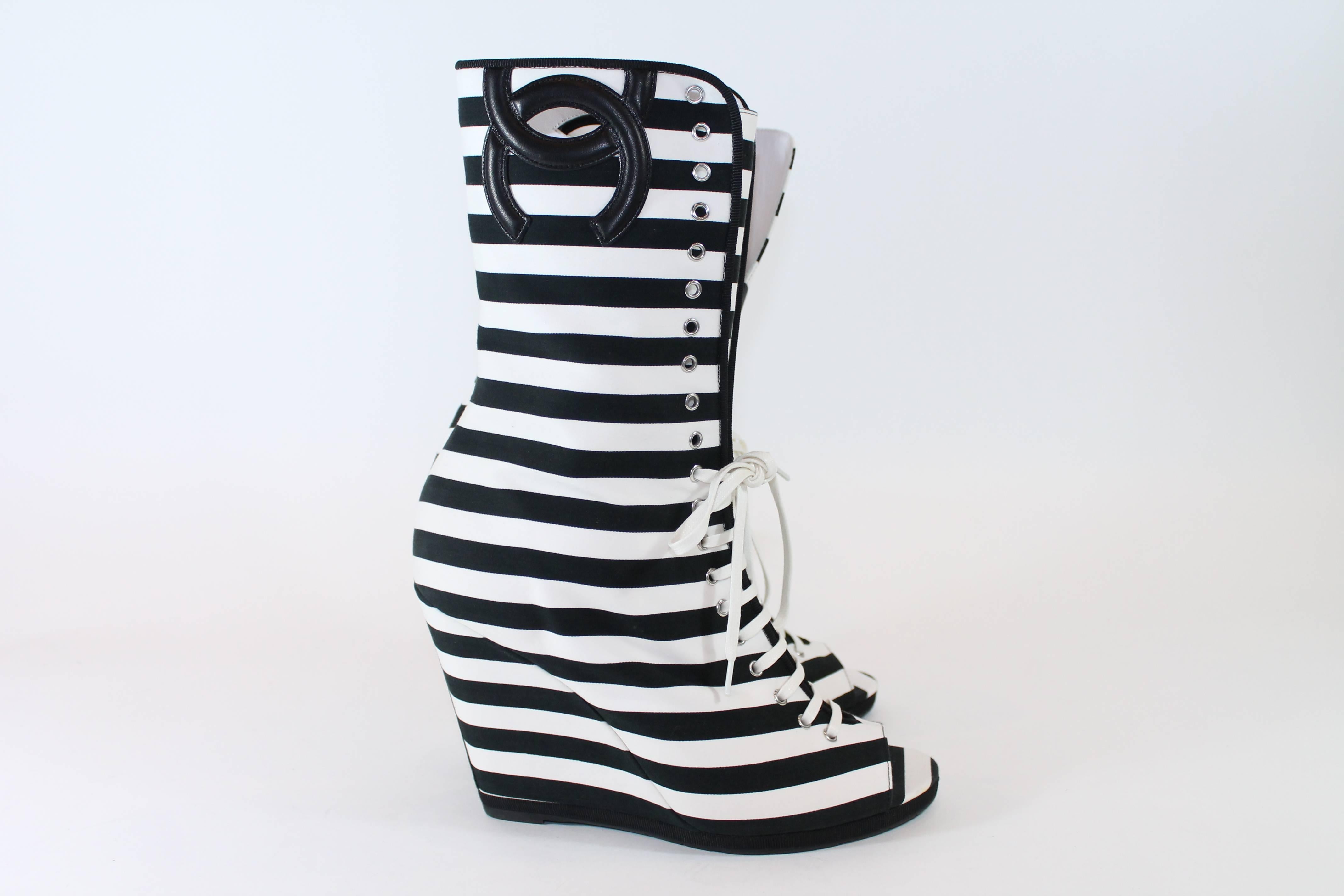 Size 41. These boots have a 4 inch canvas wrapped wedge. They are calf length with a black stitched Chanel logo at top of boot. Black and white stripes on entire shoe. Open toed with white laces. black leather soles.