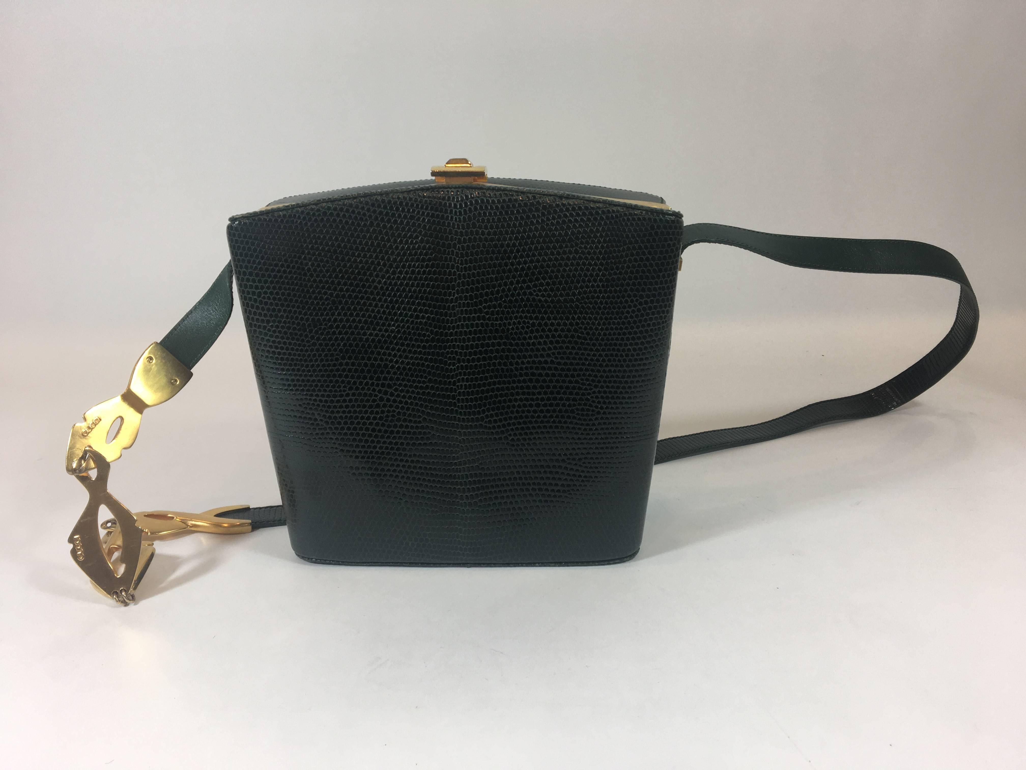 This vintage bag is made of green lizard with gold-tone hardware. Single leather strap with snap closure. Taupe suede interior with dual compartments. Includes one zipper compartment.

Retail Price: $1750