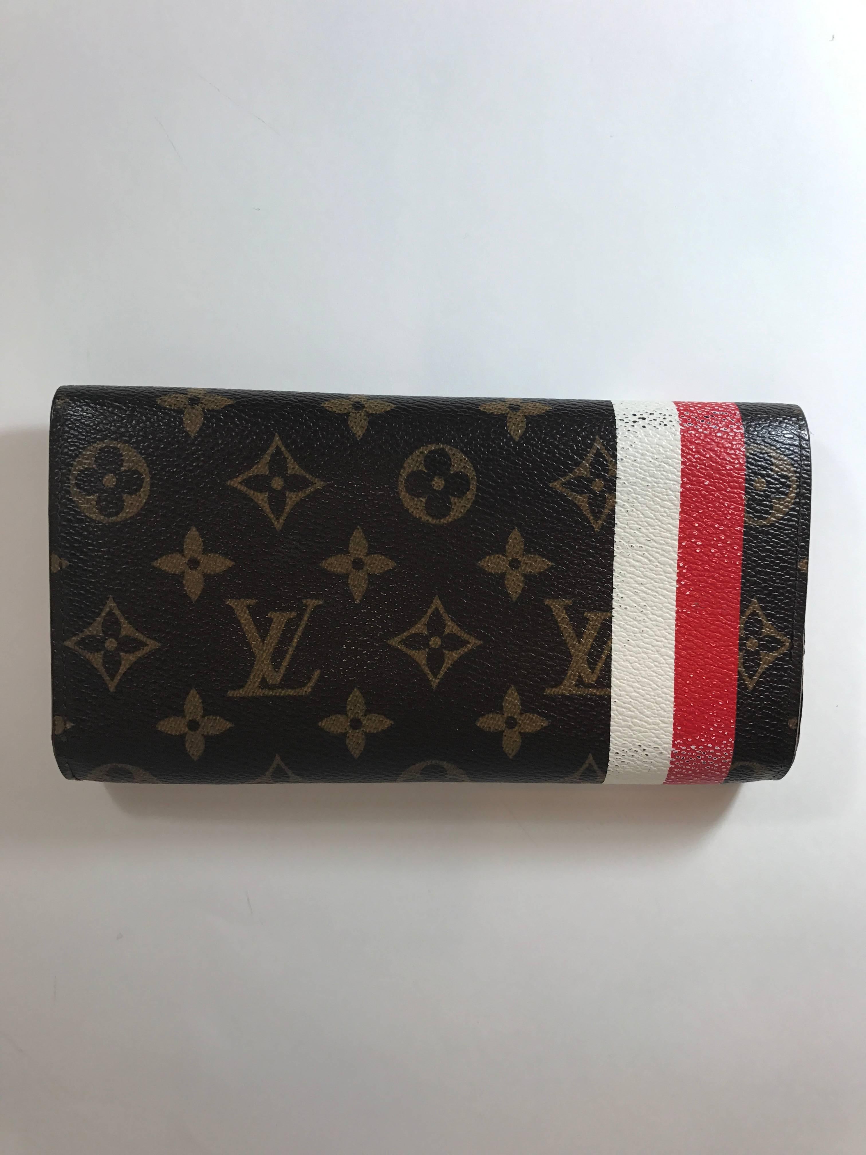 Louis Vuitton Red Monogram Groom Porte Monnaie Wallet featuring red and white stripes with the iconic Groom figure. 
Red Monogram Groom coated canvas
Made in France
Date/Authenticity Code: CT0075
Goldtone Hardware.
Single snap closure opening and