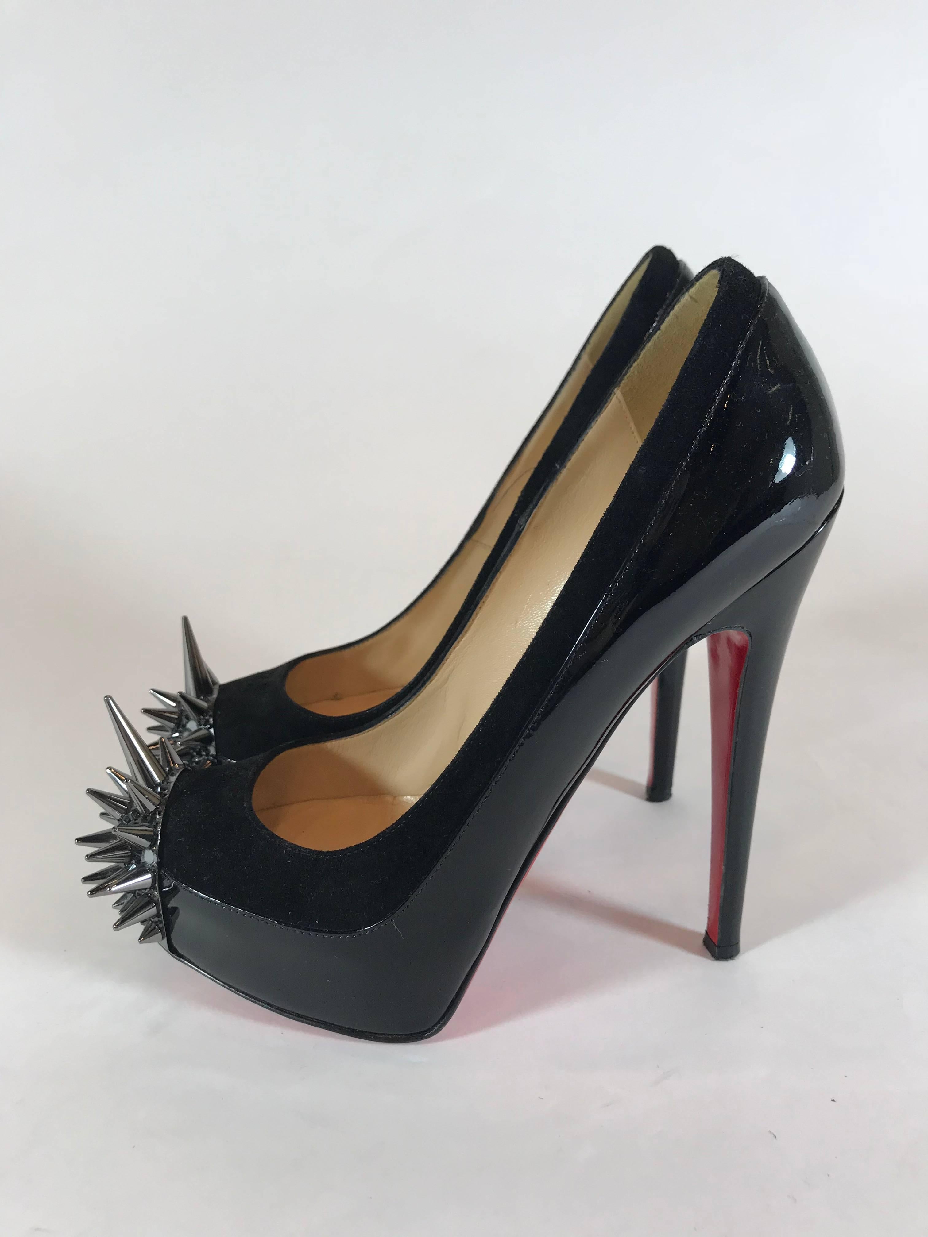 Suede and patent calfskin form classic pump silhouette. Sharp spikes and crystals encrust almond toe. 6 1/4