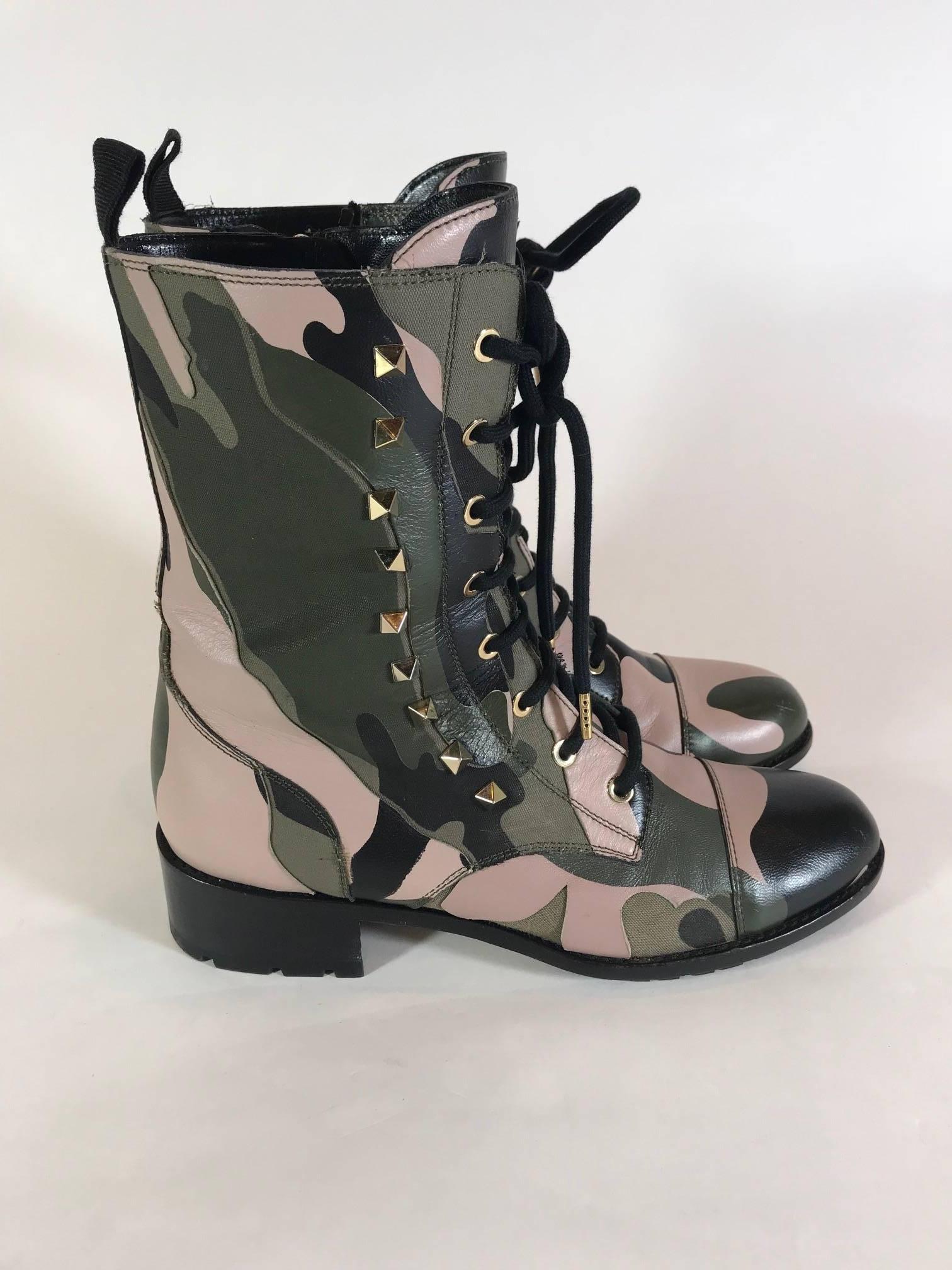 Camo-print leather and canvas upper. Lace up with signature Valentino platino pyramid studs. Shaft with loop on back and an inside zip. 1 1/2