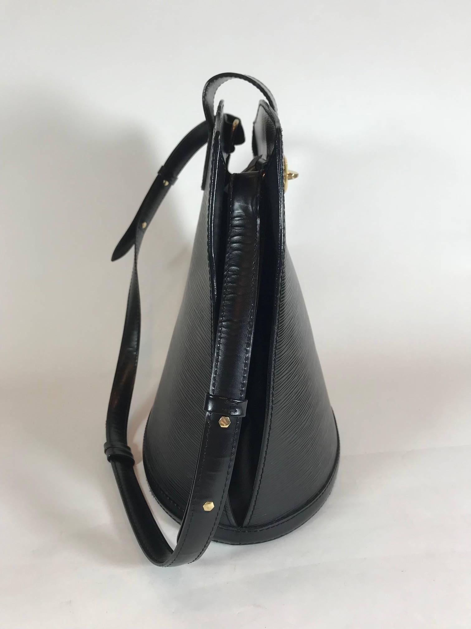 Louis Vuitton Noir Epi leather. Brass hardware. Turn-lock closure. Single flat adjustable shoulder strap. Single slit pocket at interior wall.
