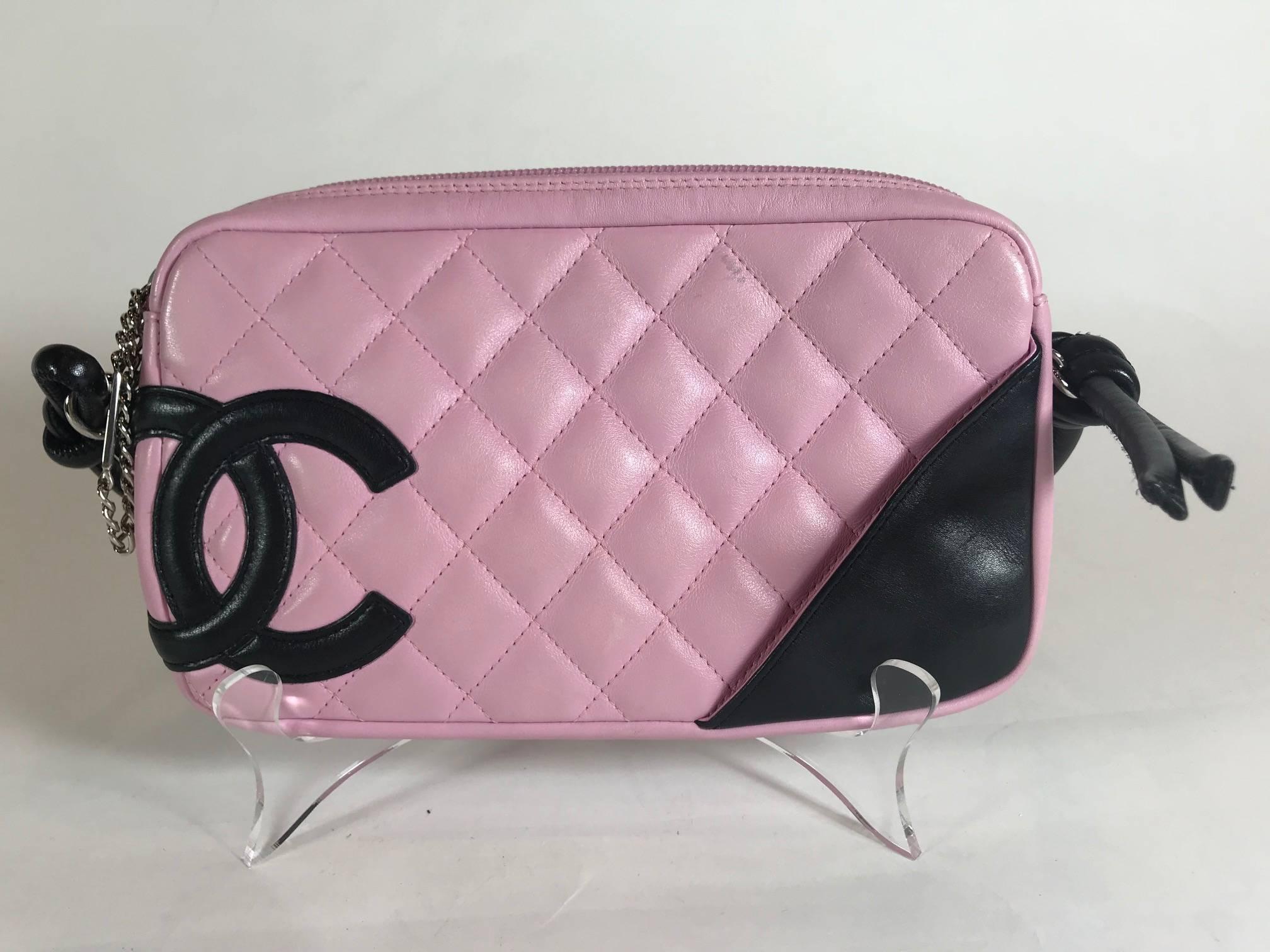 Pink quilted leather. Silver-tone hardware. Zip closure at top. Black leather trim. Single rolled shoulder strap. 