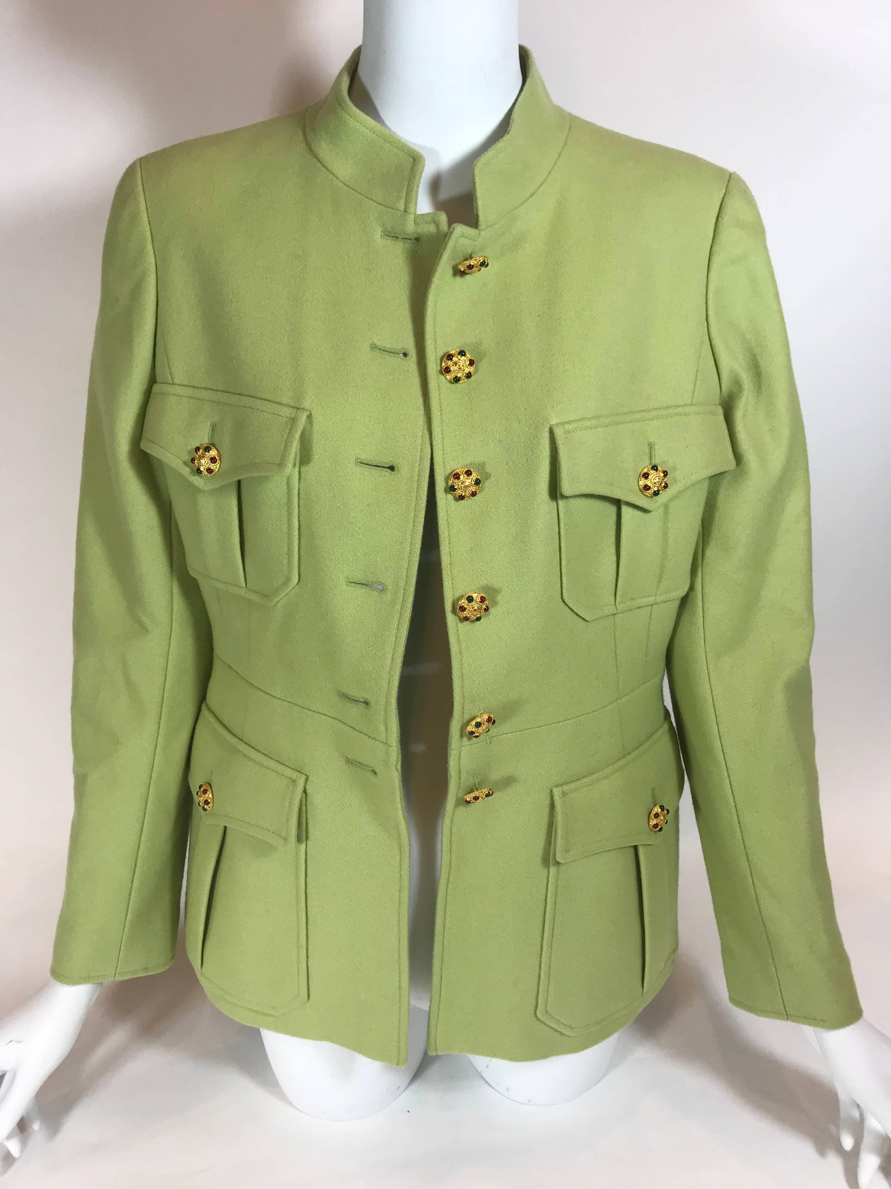 Bright green wool. Gold-tone hardware. Button up closure. Four exterior Military style pockets. Collared. Three button up closures on sleeves. 