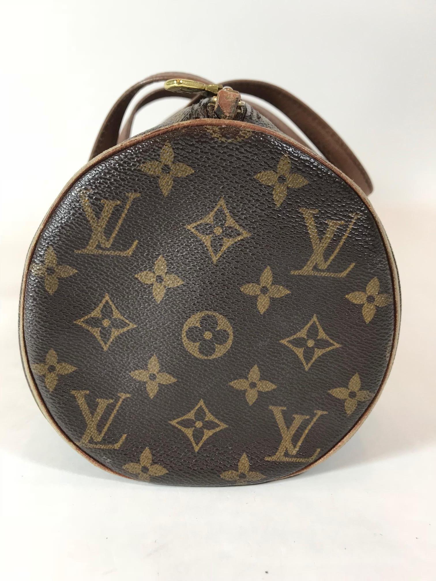 We adore this vintage Louis Vuitton Papillion 30 Monogram Handbag with an adorable inside pouch. This is the biggest bag available in the Papillon line. It is made of the traditional monogram canvas with a vachetta leather trim and straps. It has a