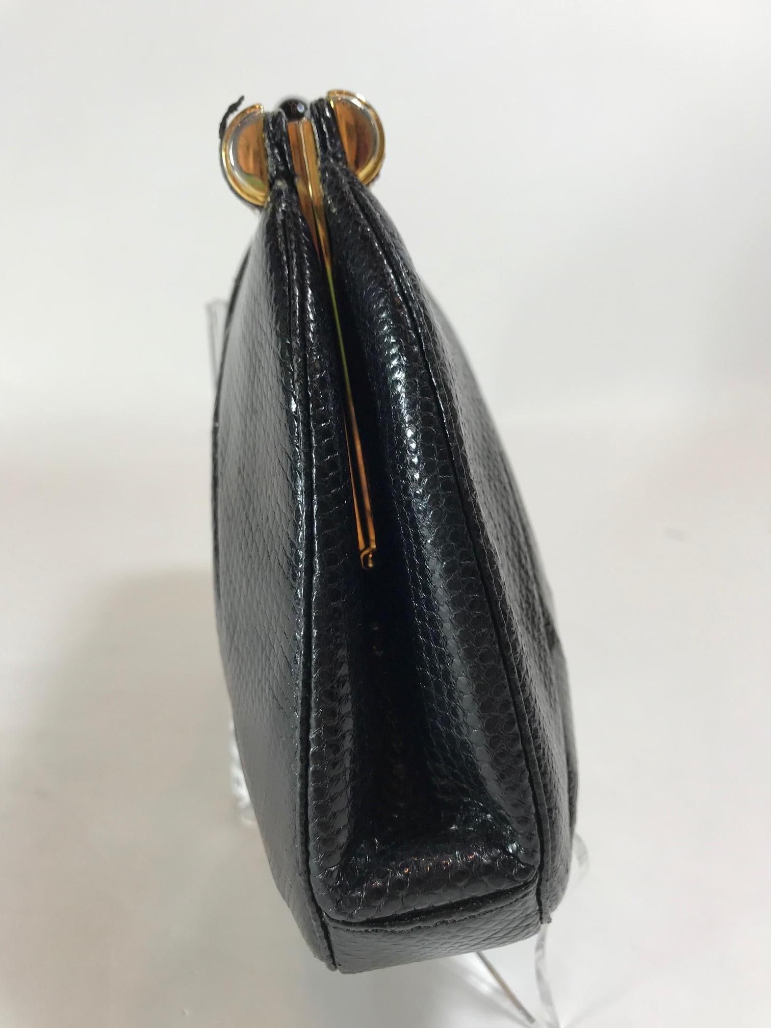 Black pleated Karung Judith Leiber frame clutch with gold-tone hardware, single drop-in flat shoulder strap, tonal grosgrain lining, dual interior pockets; one with zip closure and cabochon-embellished push-lock closure at top frame. 