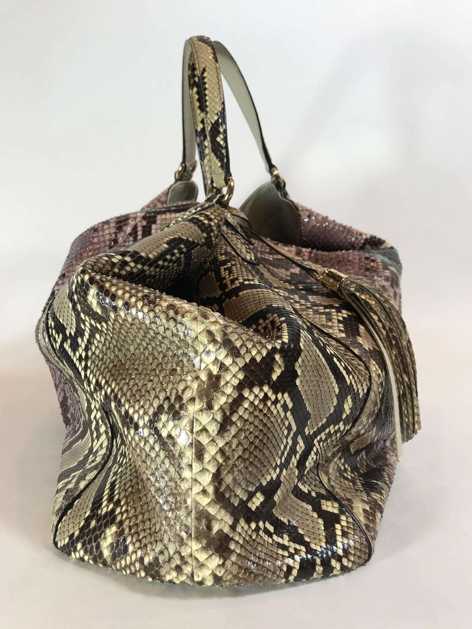 Multicolor Python featuring the iconic bold GG logo embroidered on the front. Silver-tone hardware. Dual flat shoulder straps. Detachable python tassel.  Off White leather interior. One large interior zippered pocket. Two interior opened pockets.