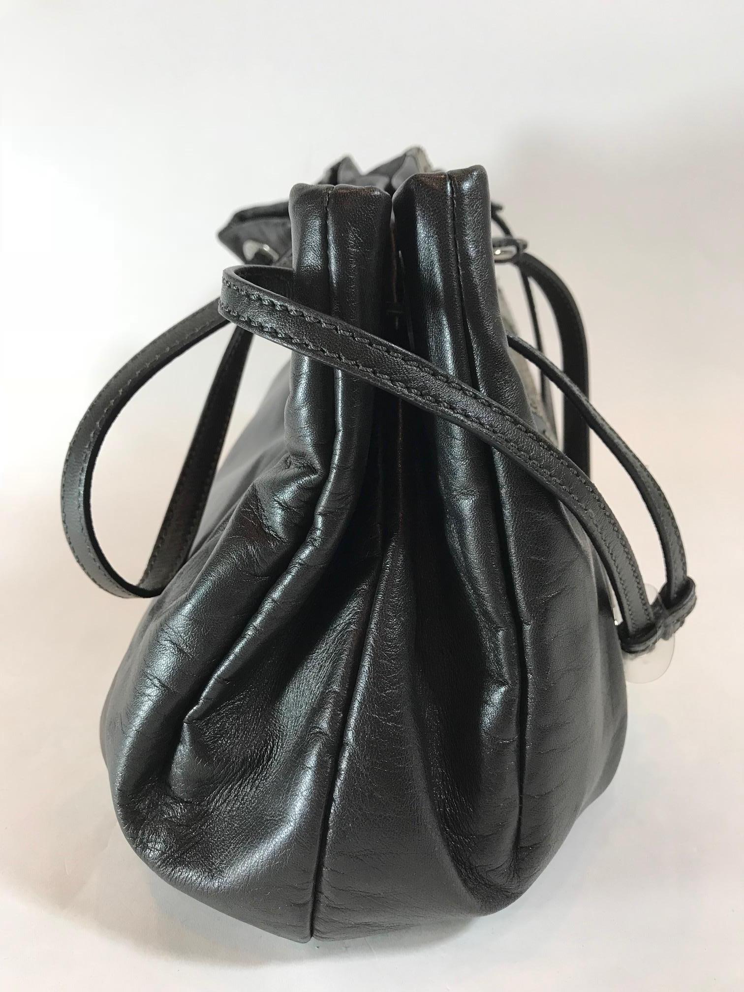 Blackish gray. Shiny beads on front reflect in different metallic shades. Silver hardware. Dual shoulder straps. Interior pocket with zipper closure. Two interior slit pockets. Features leather detailing.

