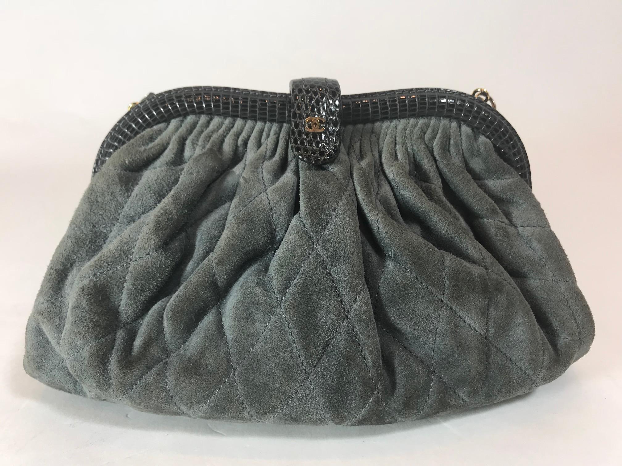 Dark gray quilted suede. Gold-tone hardware. Python trimmed detail. Top closure lock featuring small 