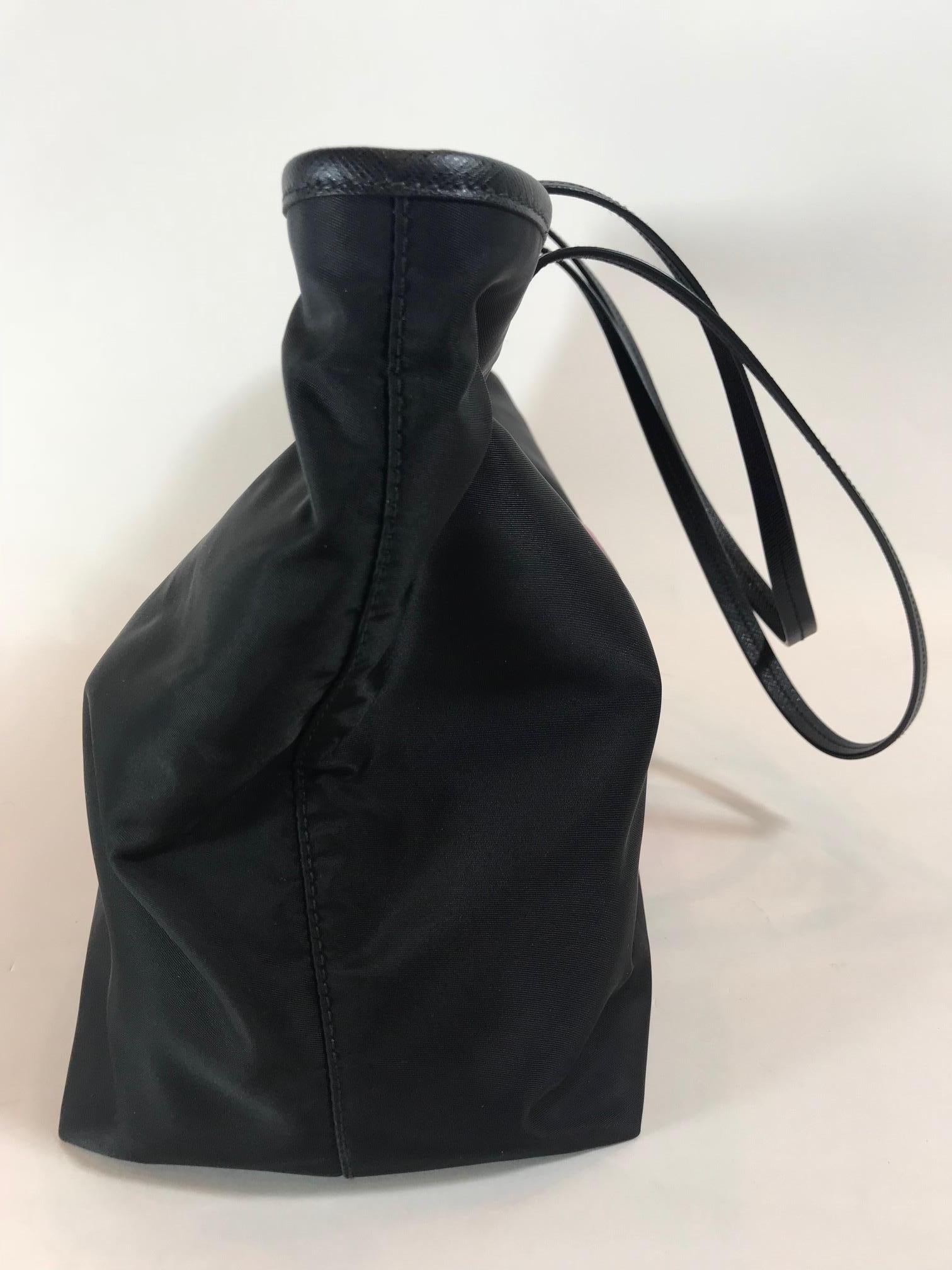 Black nylon featuring velvet buckle trompe l'oeil design. Dual flat leather shoulder straps, 10