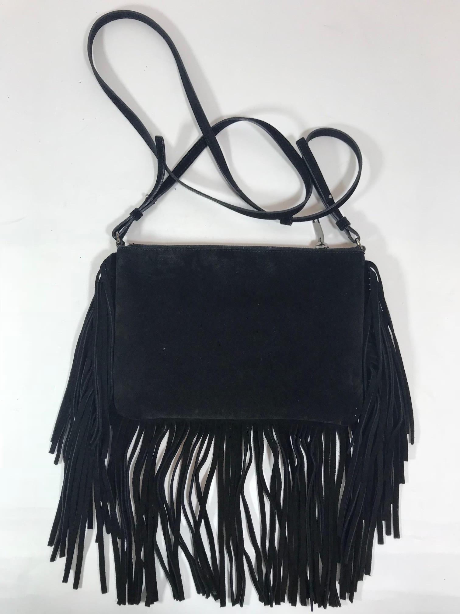 Black suede Saint Laurent crossbody bag with silver-tone hardware, suede flat adjustable strap, fringe trim throughout, canvas lining, eight pockets at interior and zip closure at top. 