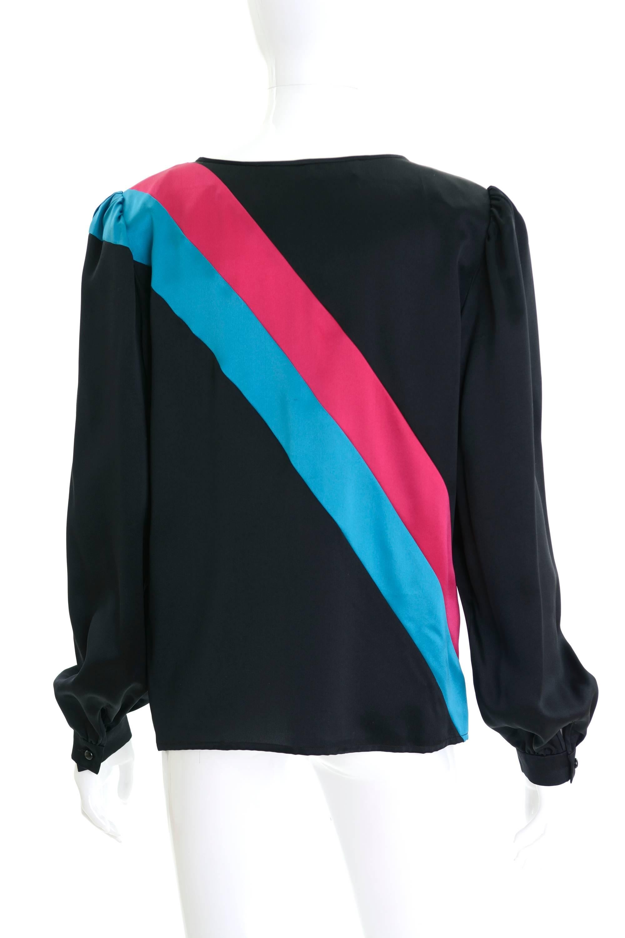 This lovely Valentino 1980s blouse shirt is in a black satin silk fabric with fuchsia and turquoise asymmetric stripes details. It has one button closure and puffed long sleeve. 

Very good vintage condition

Label: Valentino Boutique (made in
