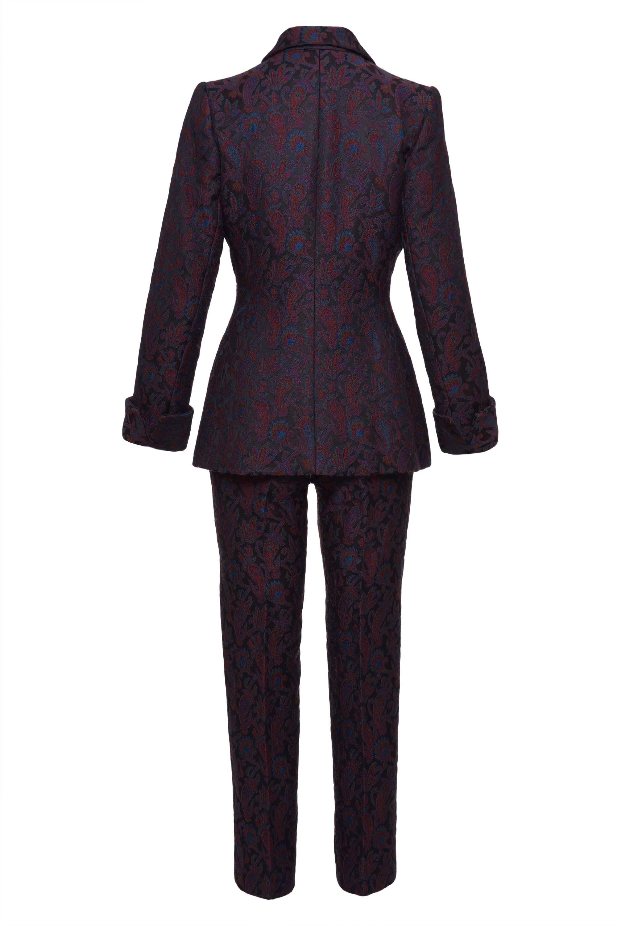 This stunning 1980s Saint Laurent Rive Gauche suit pants is in brocade paisley print wool and silk fabric. The jacket has a button jewelry and asymmetric closure and fully satin lined. The pants has front zip and button closure and two frontal