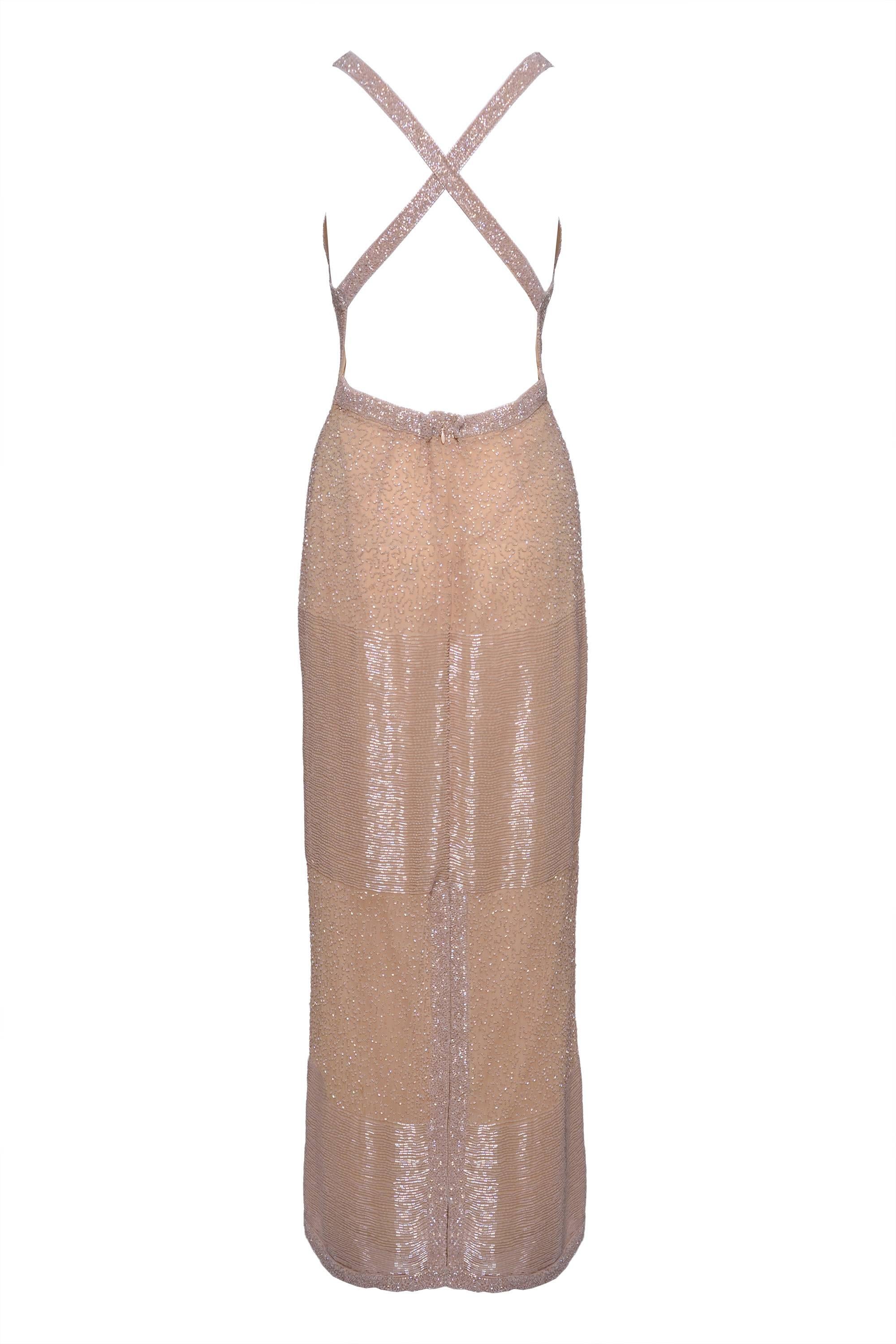This amazing evening long dress is in a cream silk with a bugle beads fabric. It's fully silk lined, back zip closure , hook and eye closure and with a back tear. Back nude and cross strap on the back.

Excellent Vintage Condition

Fabric: Silk