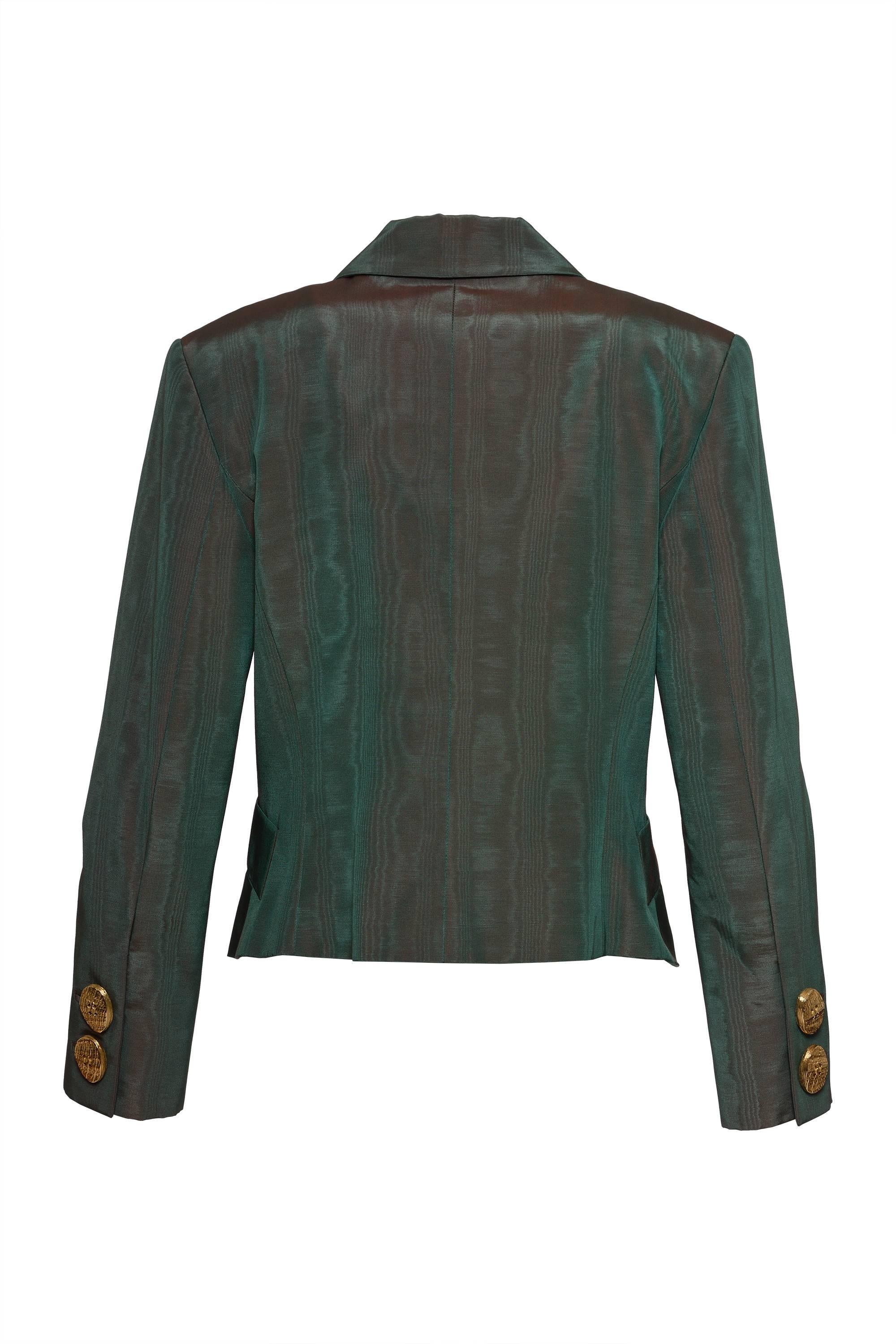 This gorgeous 1980s Gianfranco Ferré jacket is in green iridescent cotton fabric. It has two frontal pockets, metal gold botton in sleeves and one cufflinks closure in gold metal. It's fully lined. 

Excellent Vintage Condition 

Label: Gianfranco
