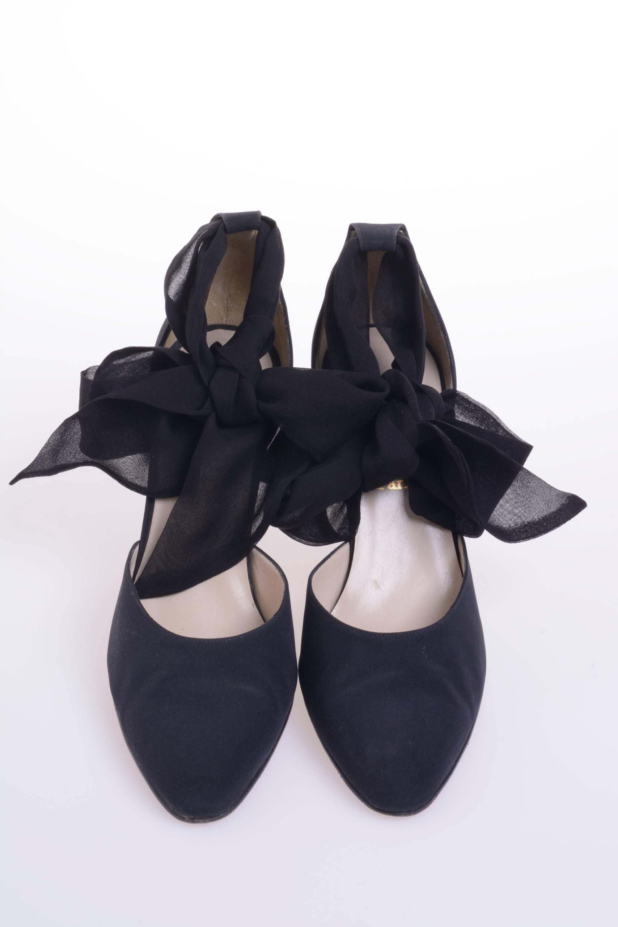 CHRISTIAN LOUBOUTIN Douce Du Desert black evening pointed shoes has nude leather lining and insole, french heel, red outsole, with a broad wrap-around ankle ties on Douce Du Desert; bring a sumptuous, organic feel made in black Crepe de Chine. Made
