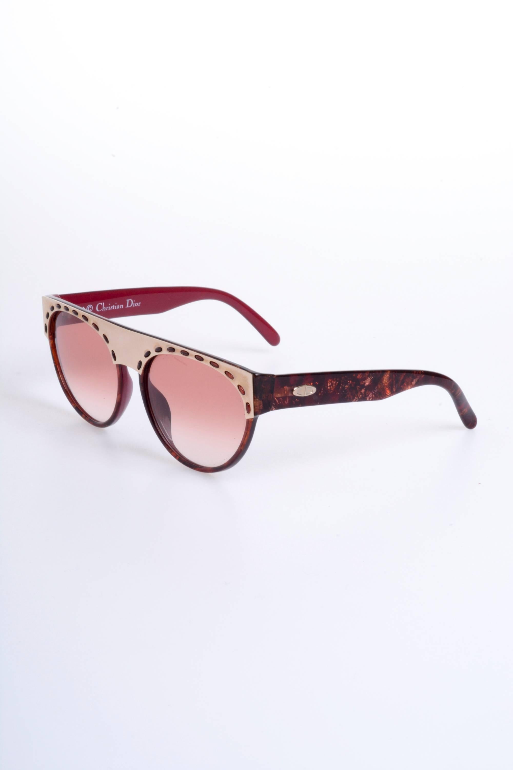 These stunning 1980s CHRISTIAN DIOR Sunglasses are in a burgundy plastic with golden metal detail. The lenses are pink and burgundy. 

Excellent vintage condition 

Brand: Christian Dior - Made in Germany

Measurements:
Temple length: 5,50