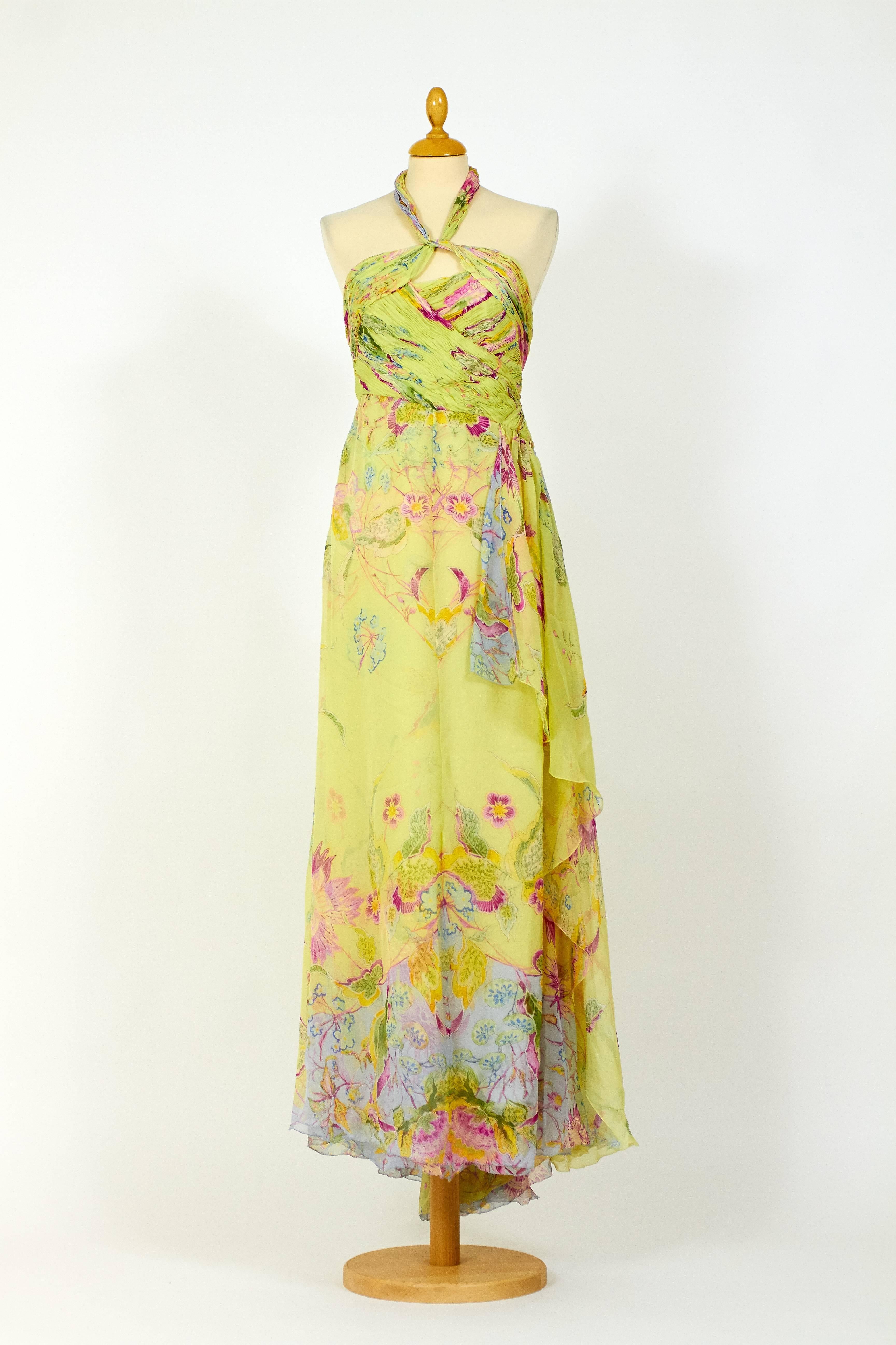 This stunning  Valentino Long dress is made of lime green organdy silk fabric with floral print. It's backless, with side zip and hook closure and has tie up straps at neck. It has asymmetric draped bodice and its fully lined. It also has a deep