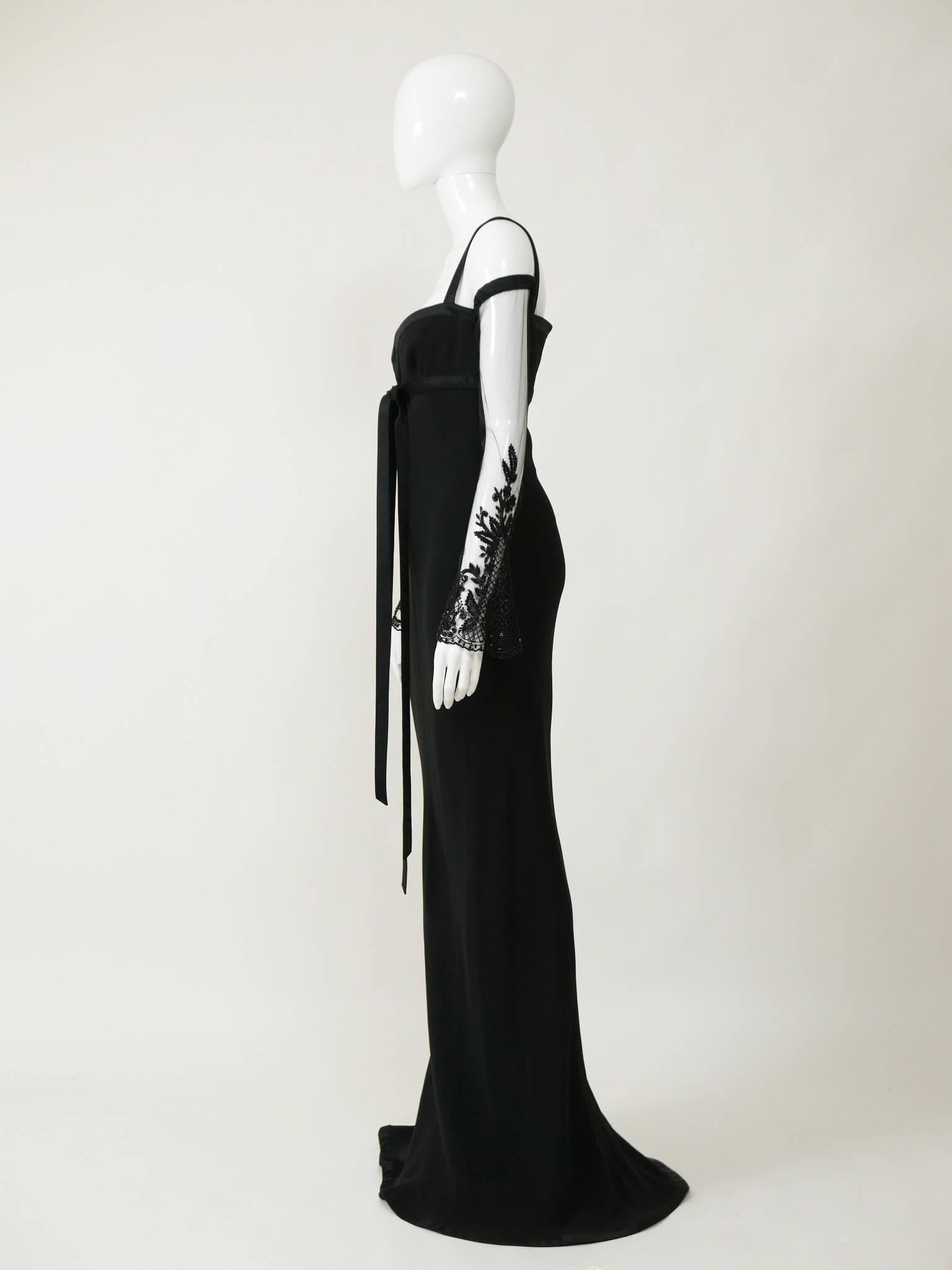 This stunning Valentino long dress is made of black crepe silk fabric. It has long sheer tulle embroidered sleeves, boning bust, shoulder straps and back zip closure. 

Measurements:
Label size 6 USA
Estimated size S
Bust 34 inch
Sleeve 21