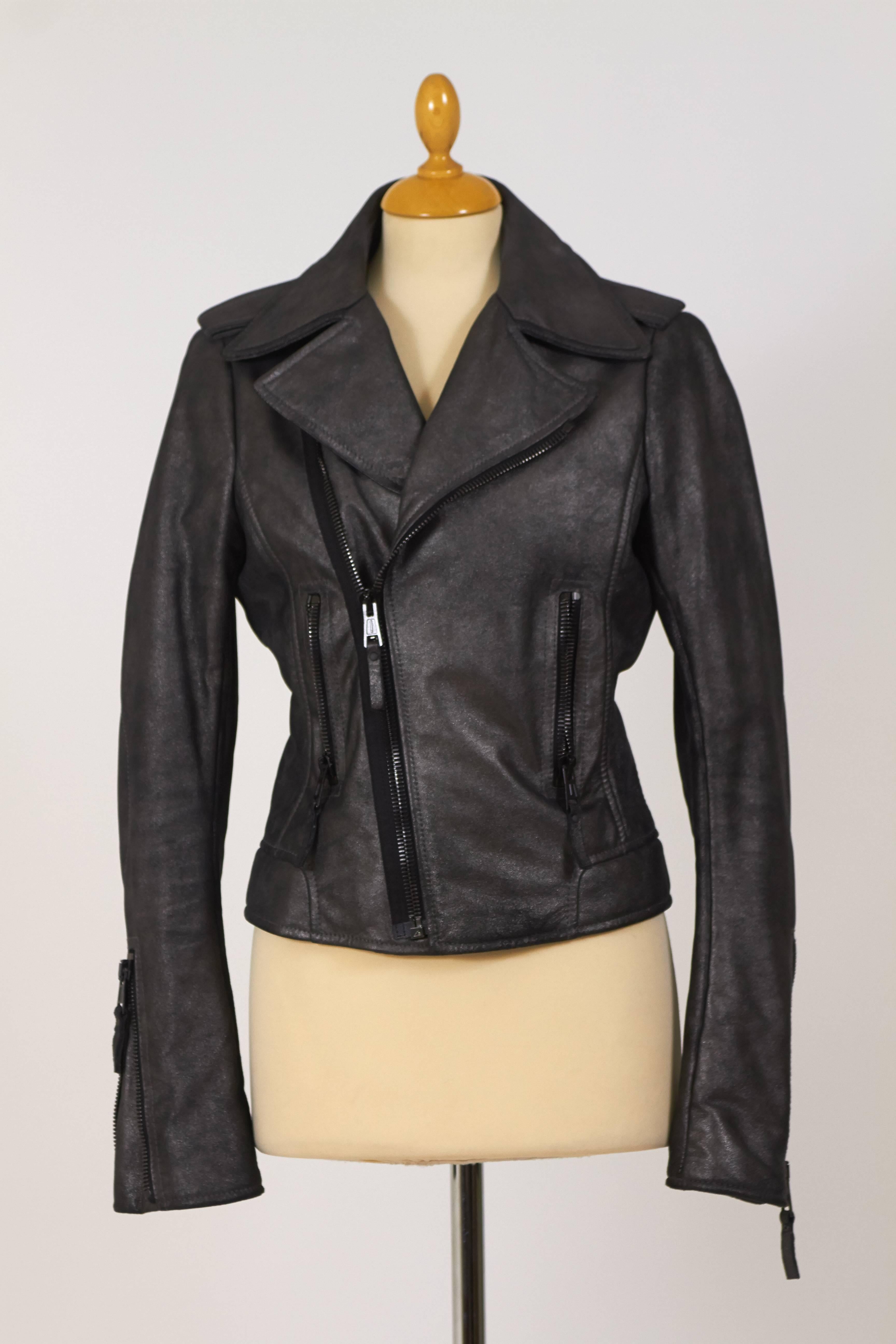 This amazing motorcycle style jacket is in a dark metallised gray leather. It has zip pockets and closure. It's fully lined with black satin. 

Measurement:
Label size 40 Italian
Estimeted size S/M
Shoulder 15 inch
Bust 34 inch
Waist 32