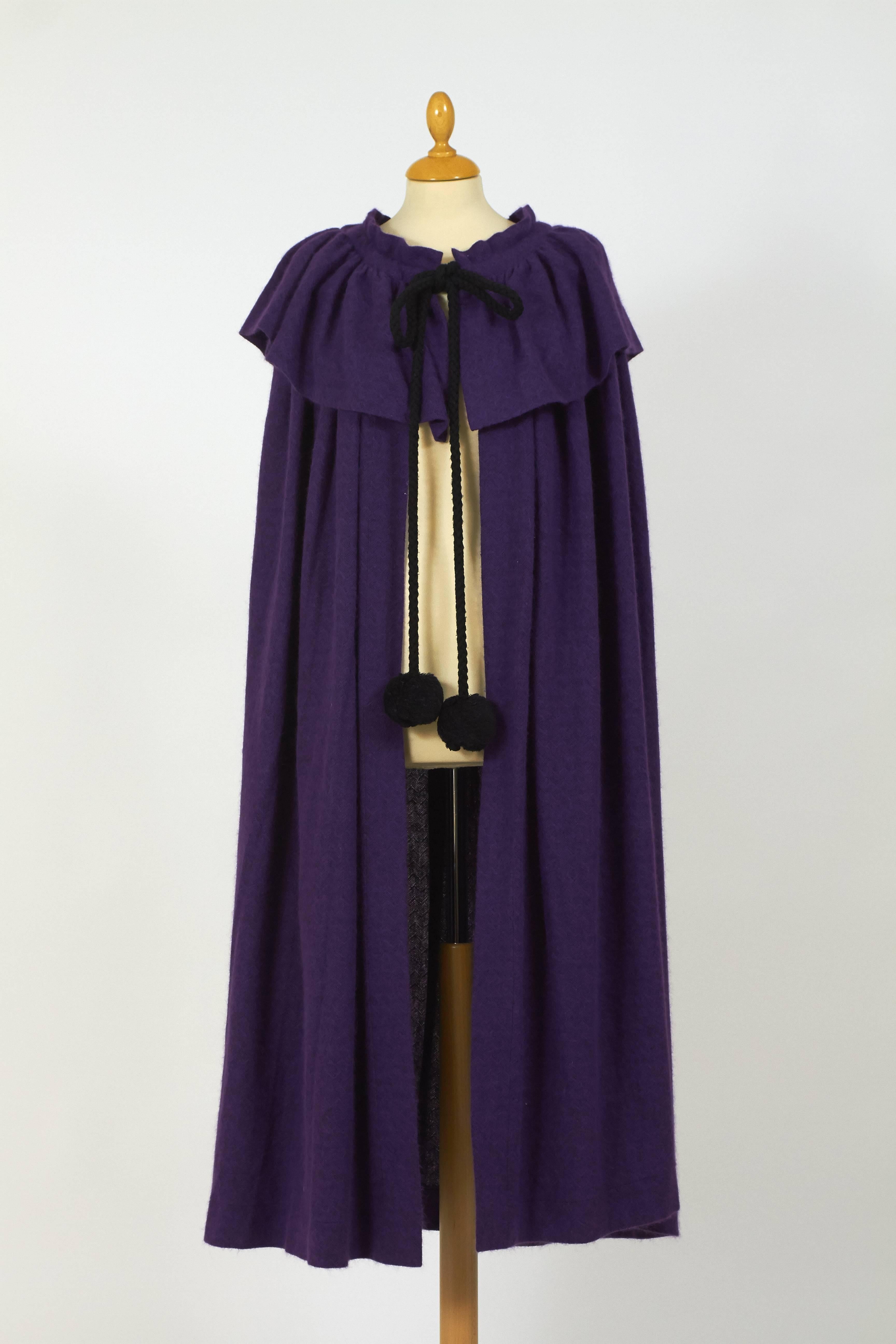 This gorgeous 1970s Yves Saint Laurent Rive Gauche cape cloack is in a purple angora wool fabric and has flounce collar and black pom pom tie cord closure. 

Measurement:
Estimeted size: one size
Max lenght 50 inch