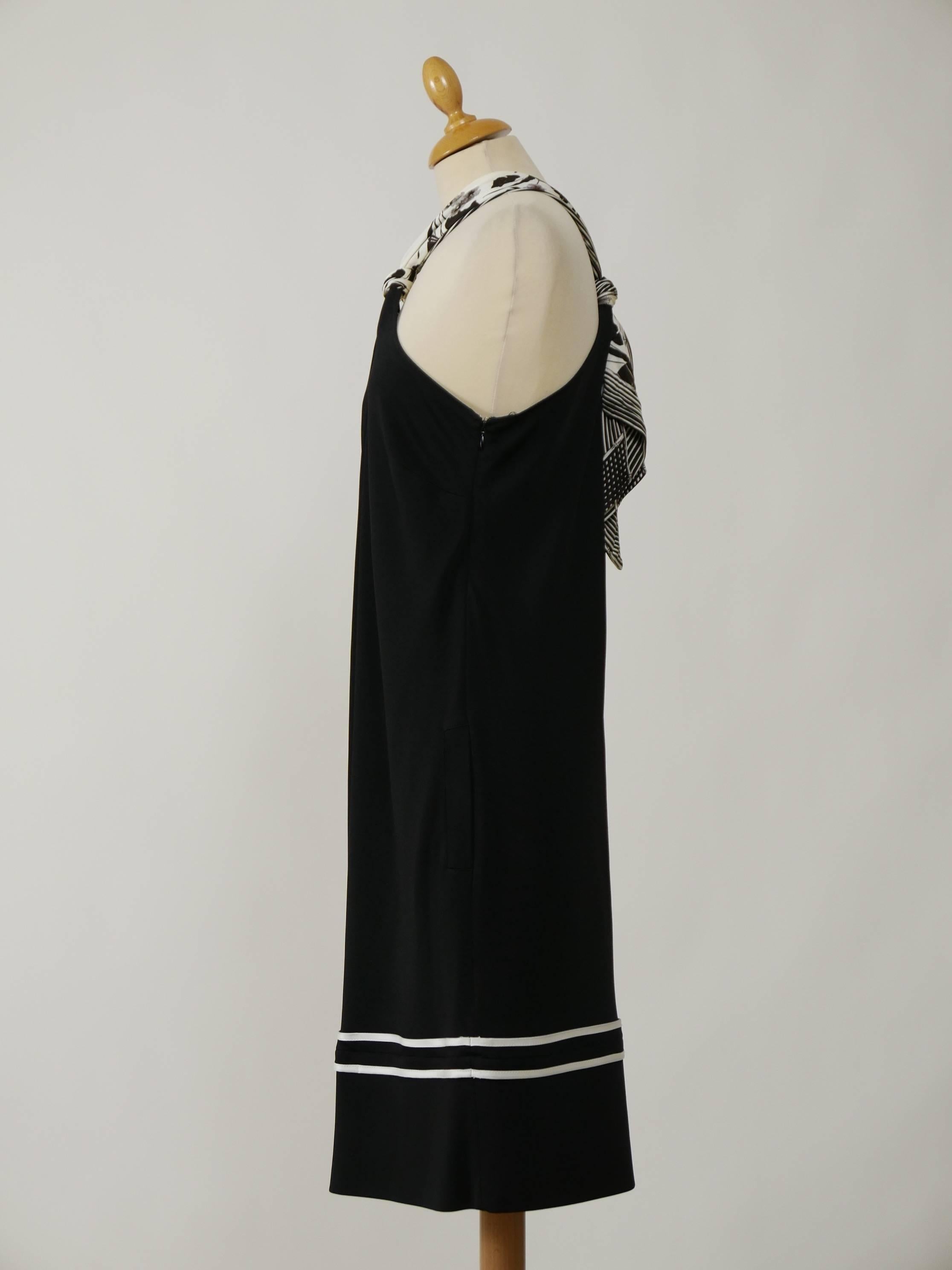 This gorgeous Roberto Cavalli dress is in black jersey with white details. It has straight line, side pockets, side zip closure and strap for the neck with black and white floral print.

Measurement (unstretched):
Label size 42 Italian / 8