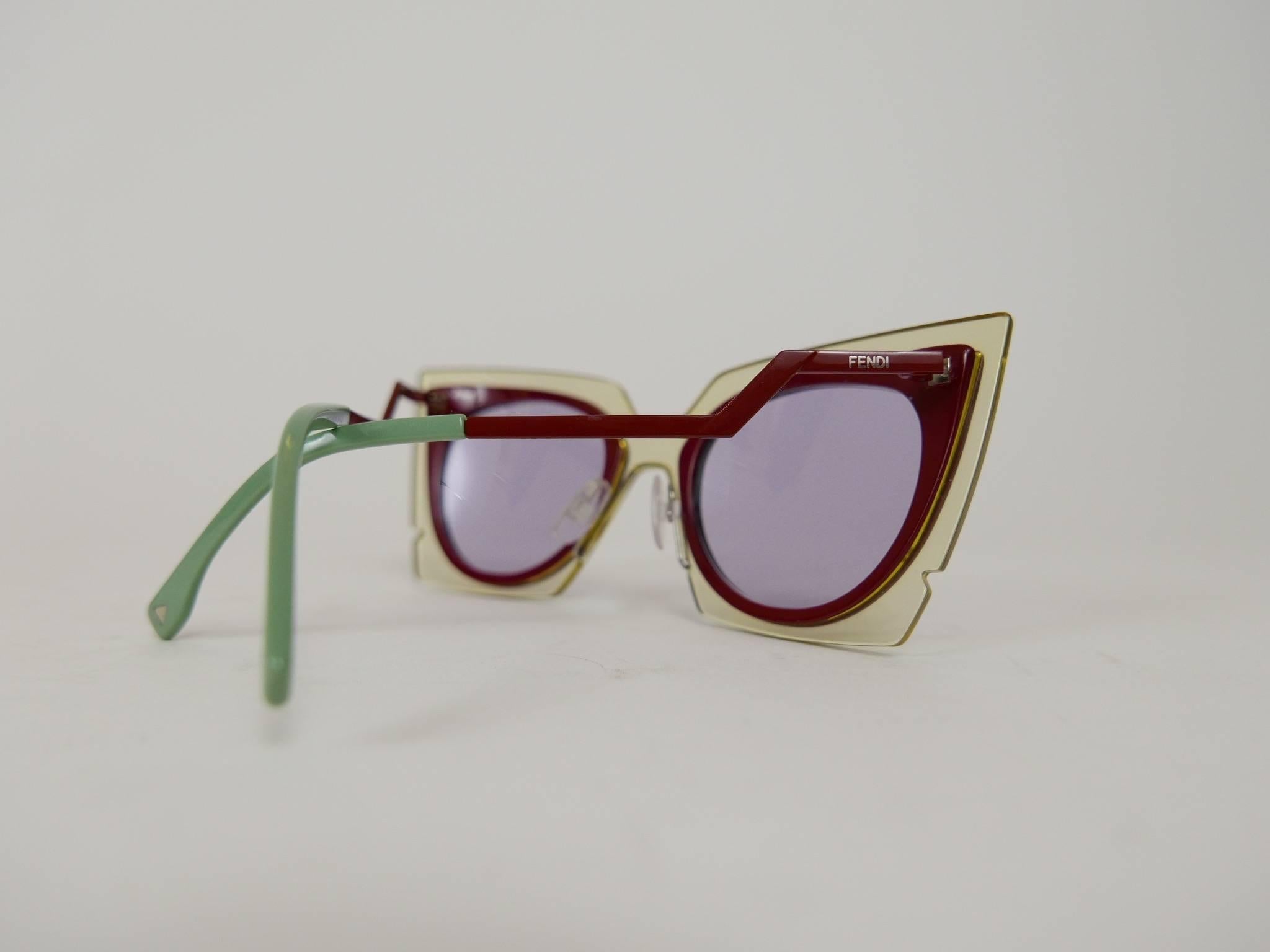 These stunning Fendi fashion show cat-eye orchid sunglasses, from the Fendi Orchidea Sunglasses Collection are in Beige Red & Burgundy colored acetate frames with square shape and irregular geometric cutouts. Thin metal arms with angled details and