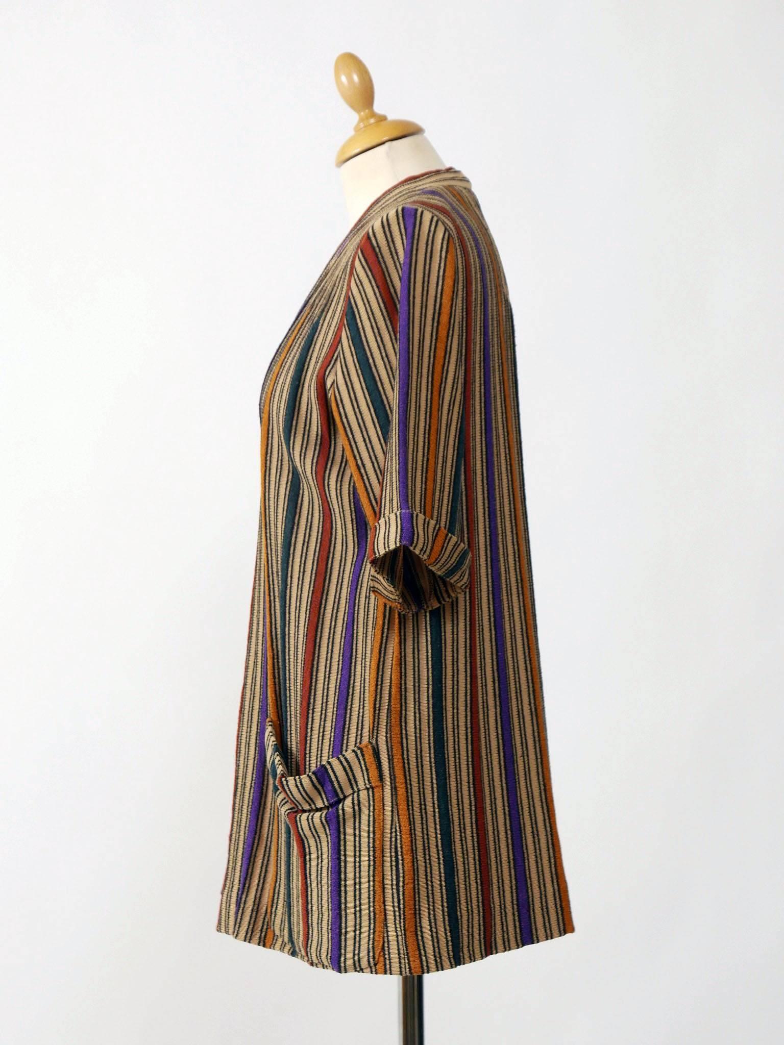 This lovely vintage 70s Missoni open cardigan is in a silk knit with classic Missoni style colorful print. It has pockets and short sleeves. 

Missoni is a high-end Italian fashion house based in Varese, and known for its colorful knitwear