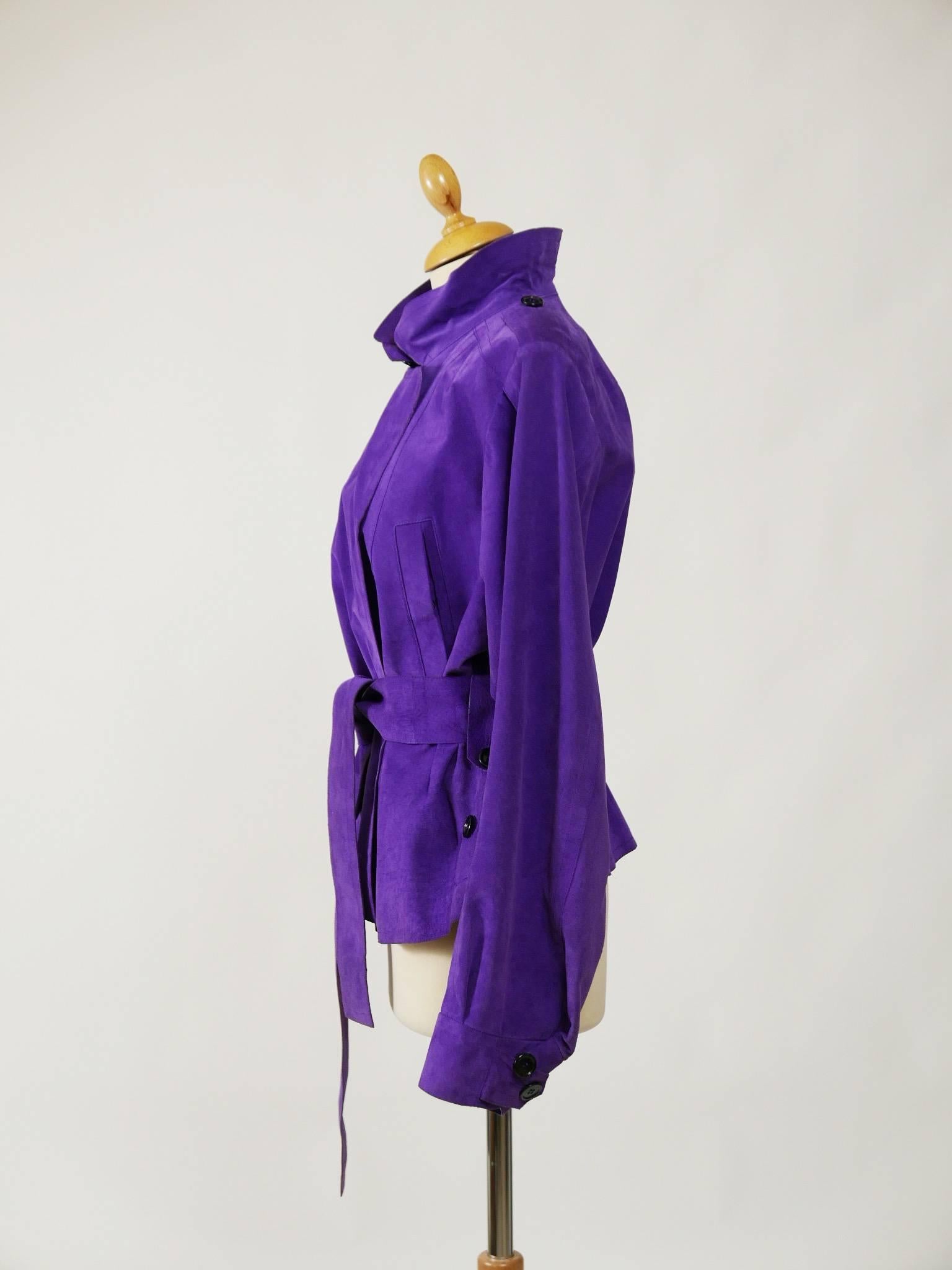 This lovely Yves Saint Laurent jacket is in a purple suede soft leather. It has assymetyric buttons closure, belt and side pockets.

Good condition

Label: Yves Saint Laurent Rive Gauche 
Fabric: suede leather
Color: