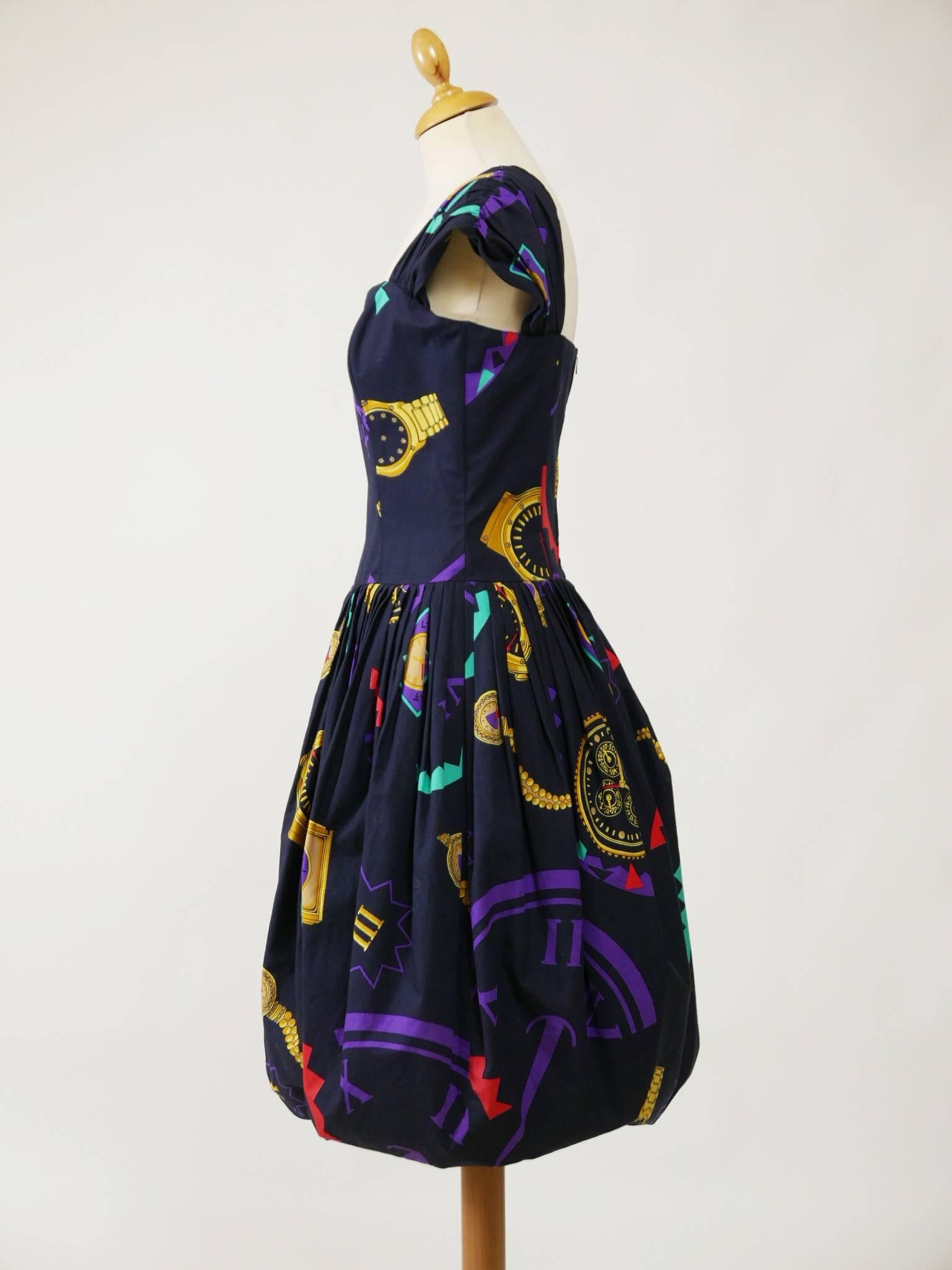 This lovely 1980s dress by Louis Fèraud is in a black cotton fabric with an amazing novelty print with colorful watches. It has back zip closure and bodice with sweetheart neckline and boning and balloon skirt and is fully lined. 

Very Good