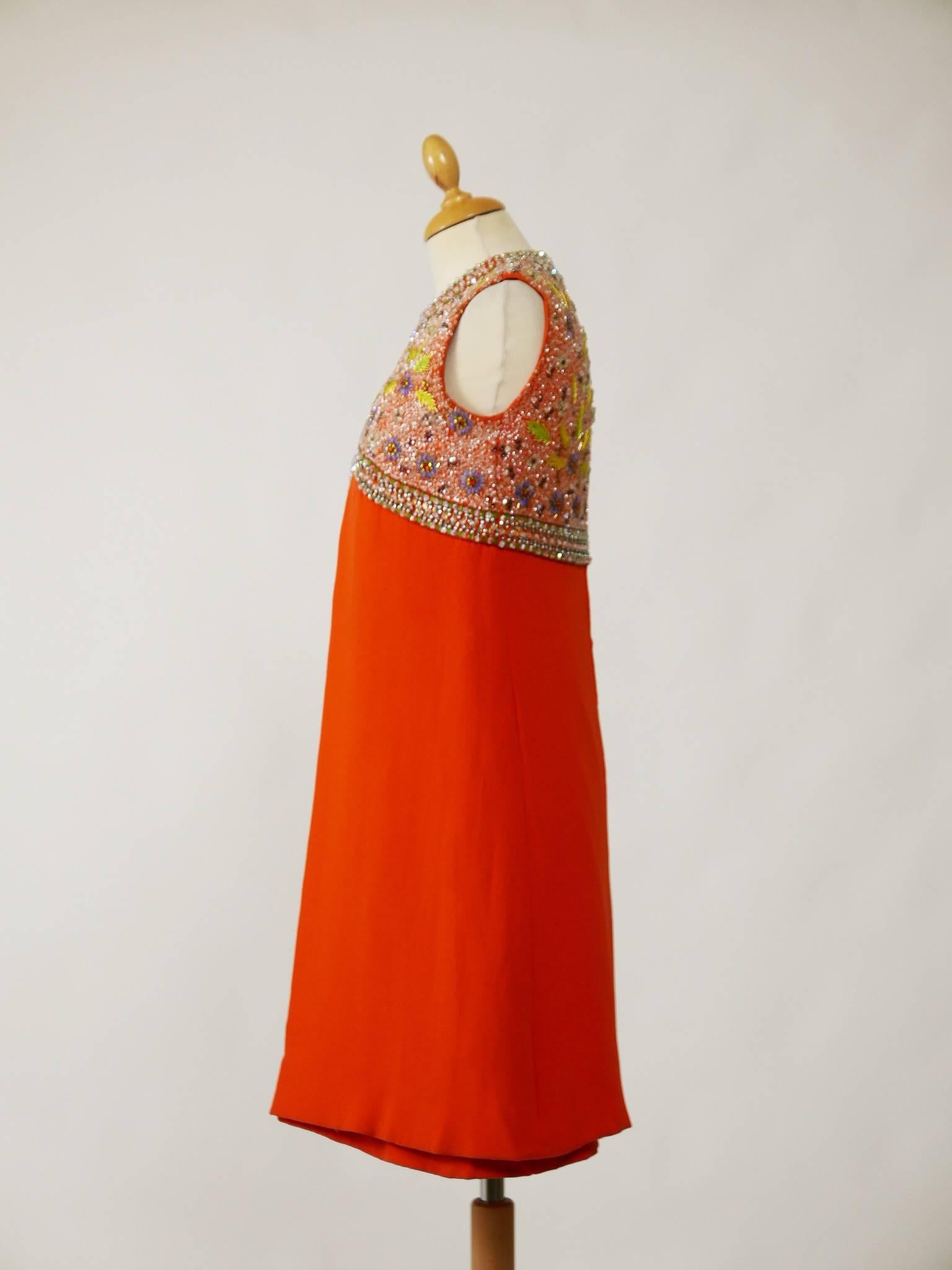 This amazing 1960s mod dress set is in an orange silk fabric with fabulous beaded embroidered. It has sleeveless two pieces dress with back zip closure. It's fully lined. 

Very good vintage condition

Label: N/A
Fabric: Silk/beadeds
Color: