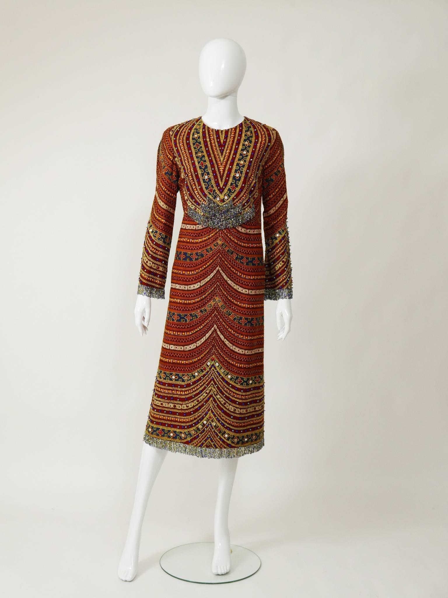 This amazing Pirovano 1970s dress is in a fabulous embroidered beaded ethnic print silk fabric. It has long sleeves with beaded fringes and back zip closure. It's fully satin lined.

Good vintage condition

Label: PIROVANO Milano
Fabric: