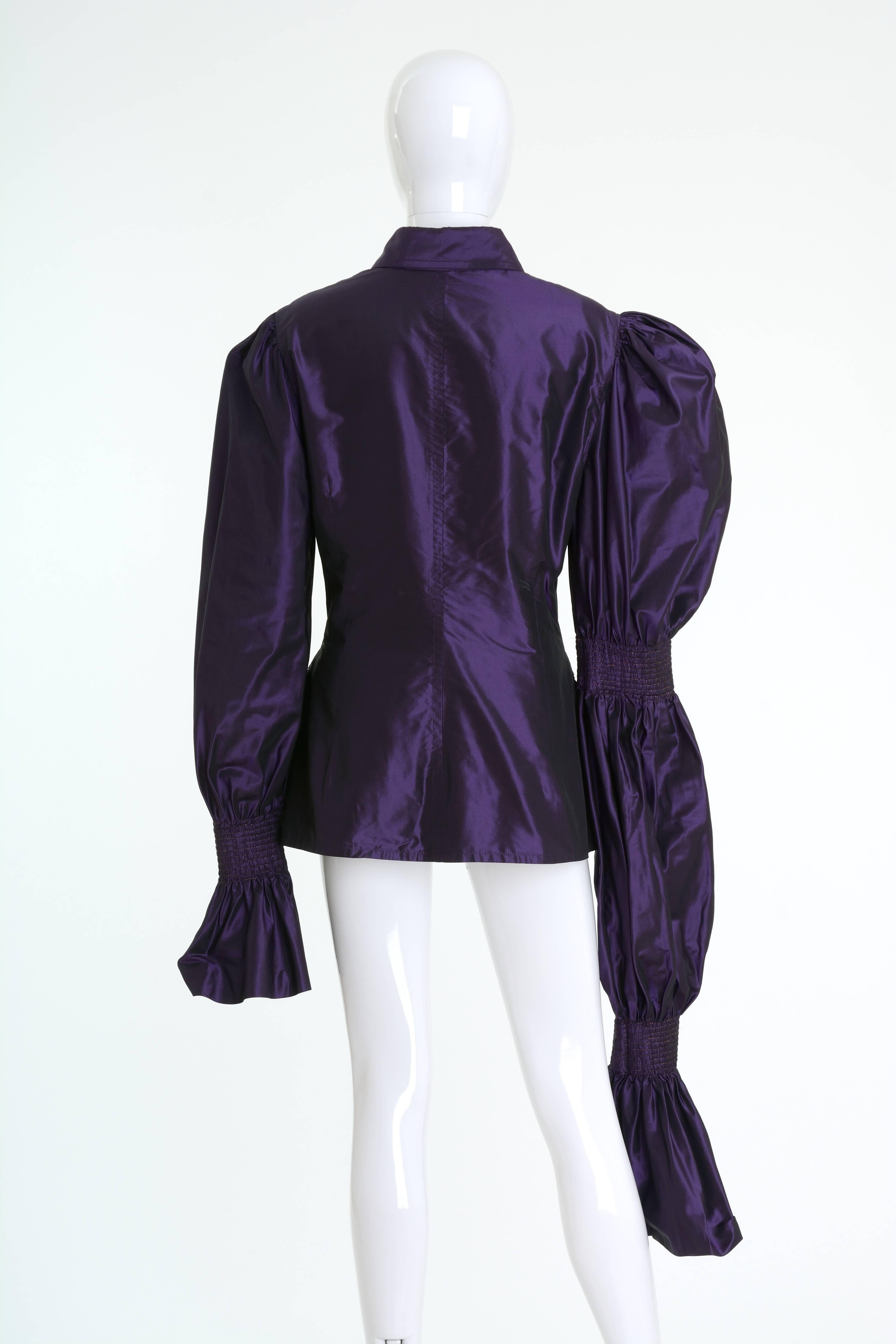 This amazing 1990s Gianfranco Ferrè blouse jacket is in purple silk taffeta fabric and has large puffed asymmetric sleeves with lurex details and fitted line with fabric buttons closure and frontal flap pockets. 

Very good vintage condition

Label: