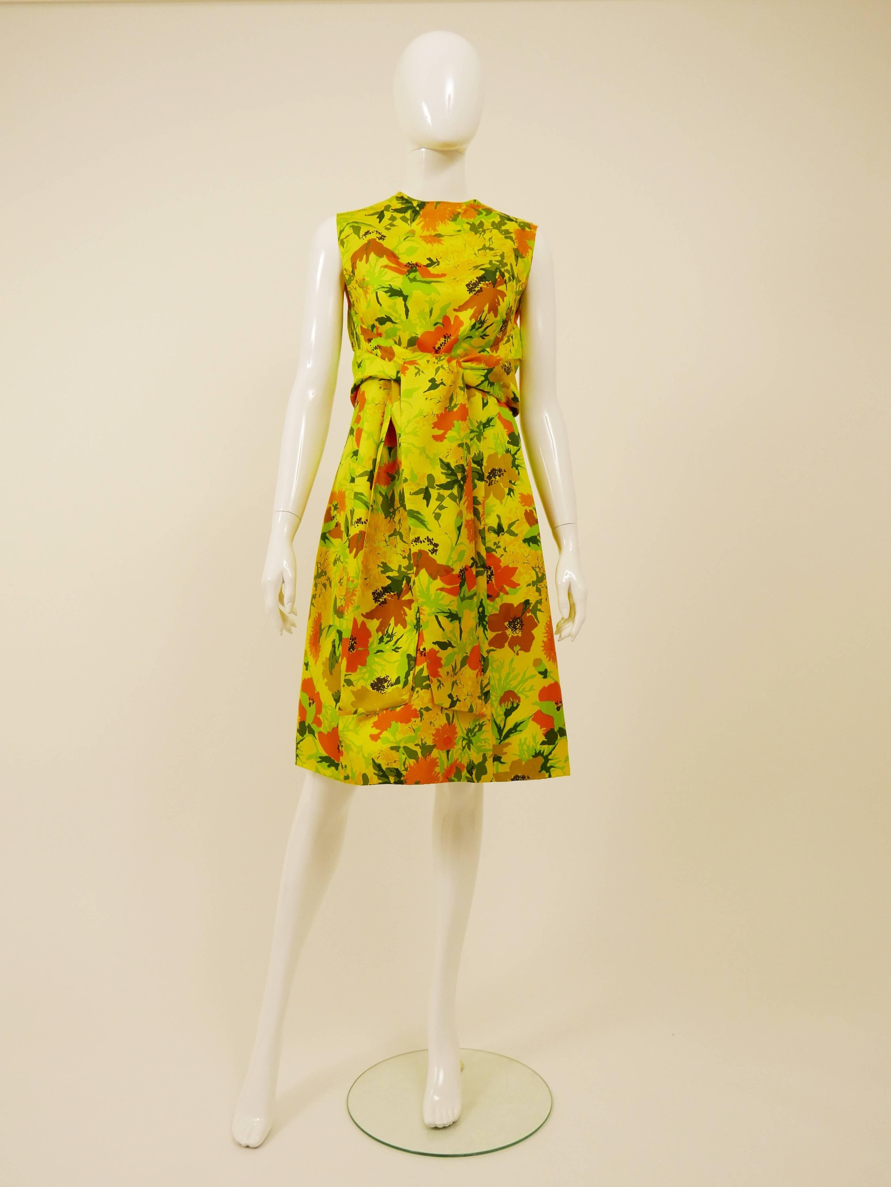This lovely Italian tailored 1960s cocktail dress is in a yellow silk fabric with floral print. It has a sash belt bolero detail, A-line and back zip closure. It's fully lined.

Very good vintage condition
 
Label: N/A
Fabric: silk
Color: