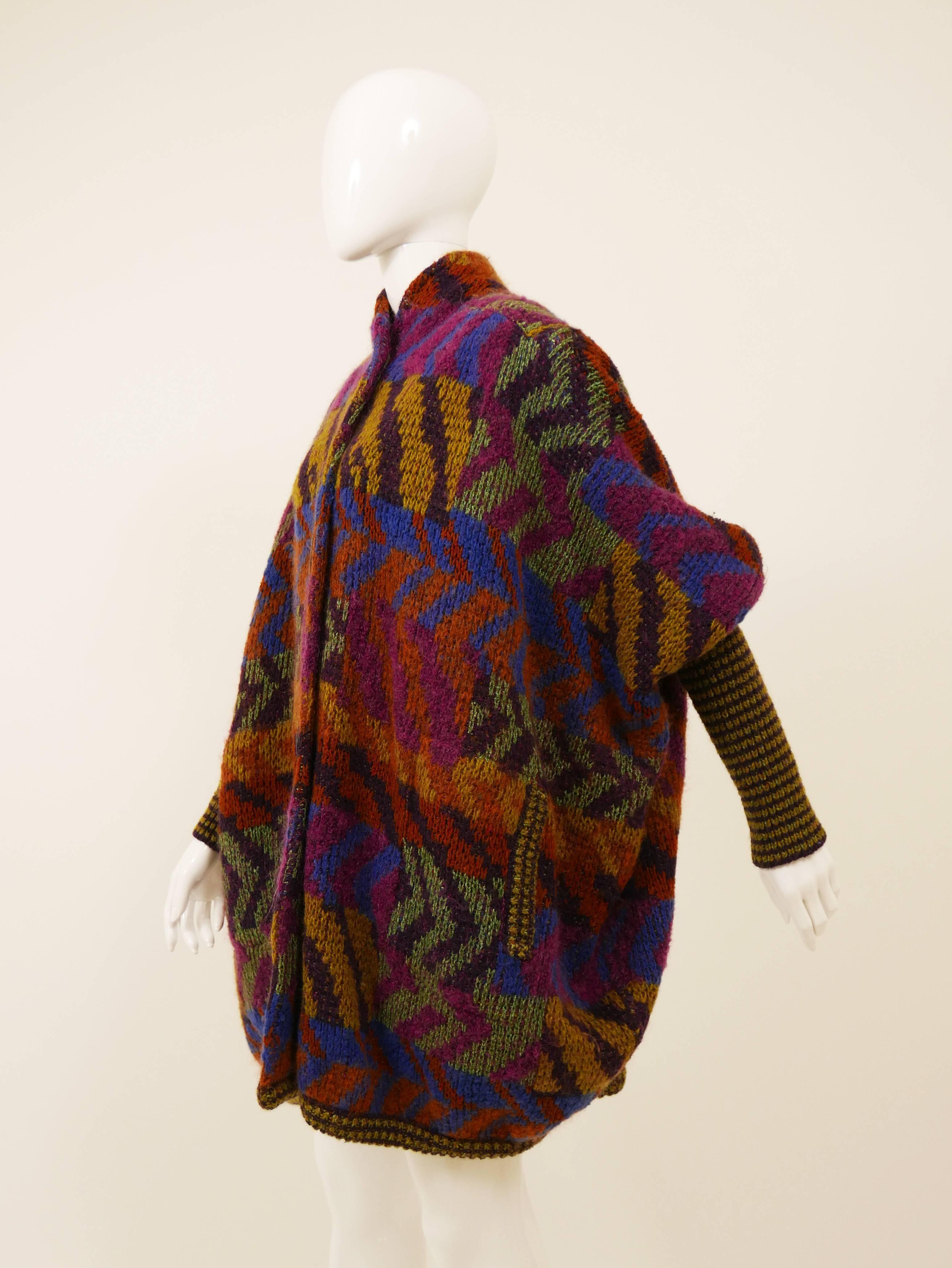This beautiful 1980s Missoni cardigan jacket is in a wool knit with classic Missoni style abstract print. It's oversize style with two side pocket, big plastic buttons closure and amazing dolman sleeves.

Missoni is a high-end Italian fashion house
