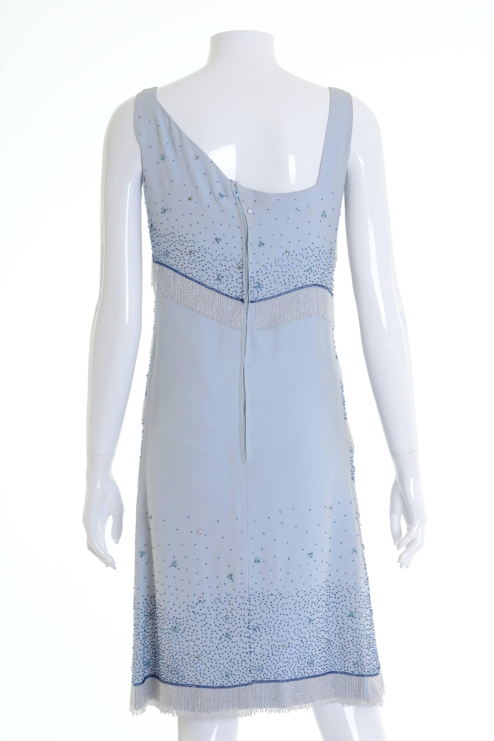 This amazing tailored 1960s Italian cocktail dress is in a fabulous light blue silk fabric with amazing glass beaded, rhinestones and fringes. It has back zip closure and hook. It's fully lined.

Good vintage condition

Label: N/A
Fabric: