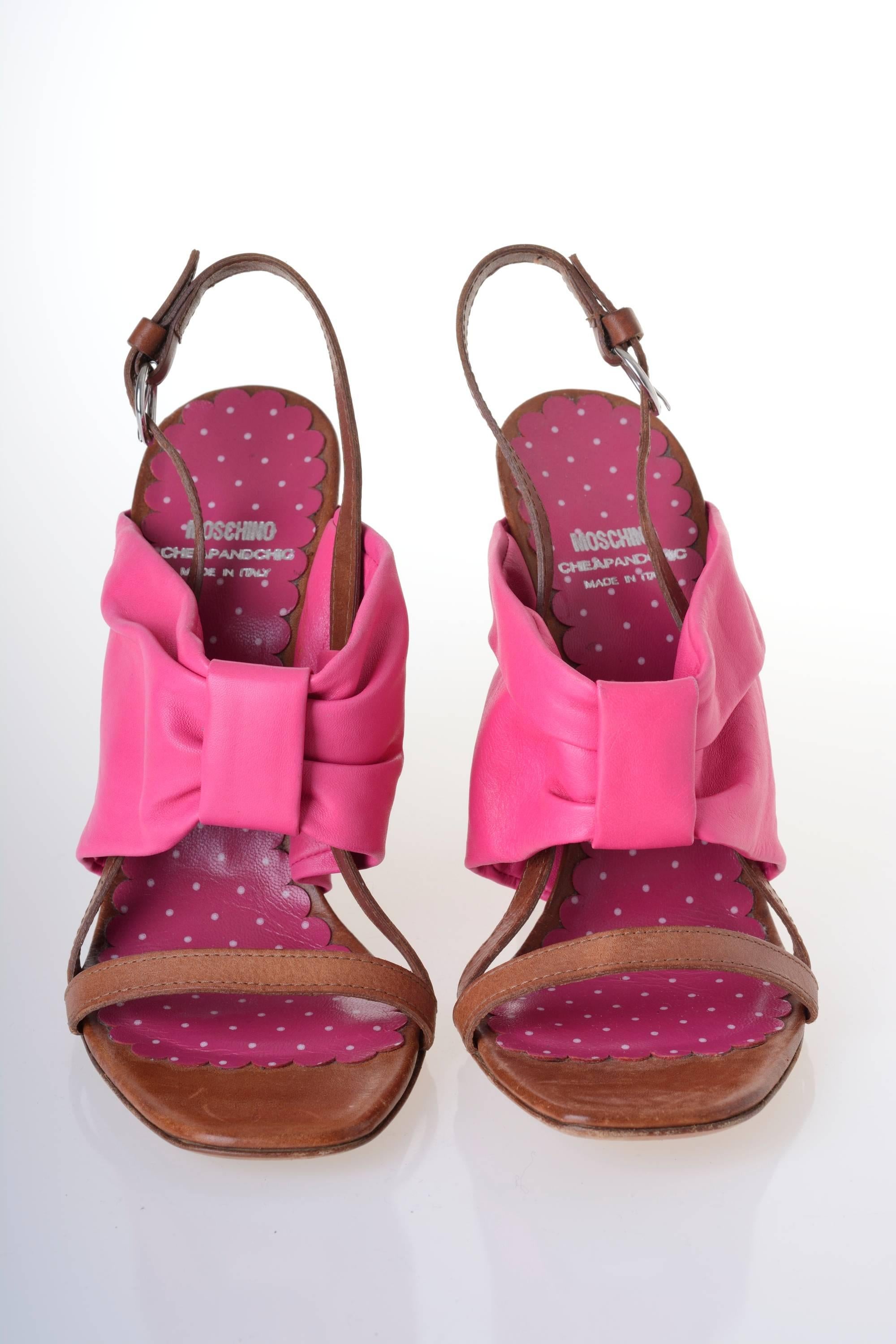 These lovely sass wedges add a great burst of sunshine to any look!
Tan leather with fuchsia bow inspired strap.
Slingback heel with buckle closure.
Stacked wood wedge heel.
Leather sole.
Fuchsia polka dot print leather insole.
Shoes are in