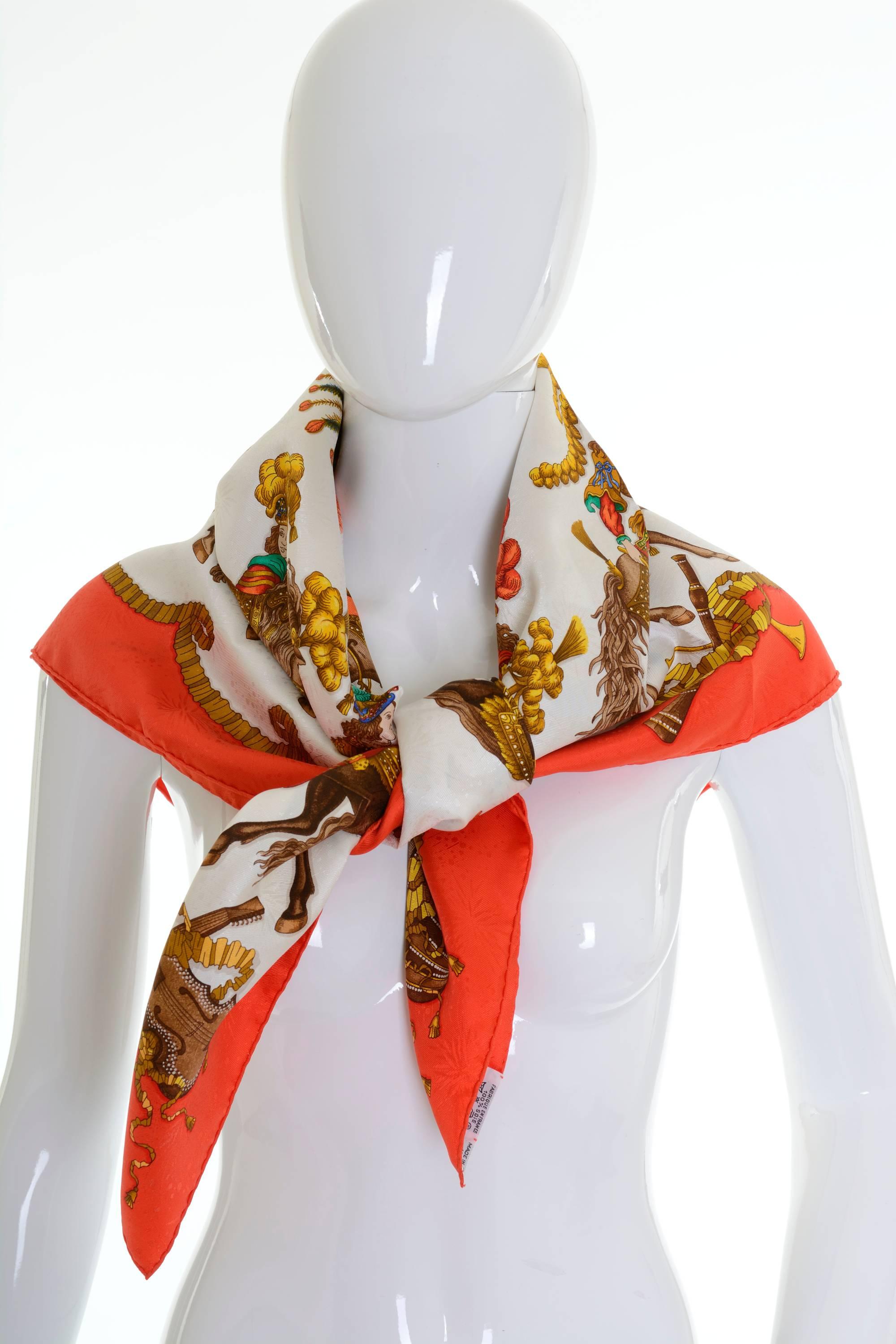 This authentic Hermès Scarf is 100% silk and has white background with equestrian motif, with red hand-rolled edging. 

New condition with Original Orange Box (never used, very fresh crisp)

Design by Michel Duchene, first issued in 1994 -Made in