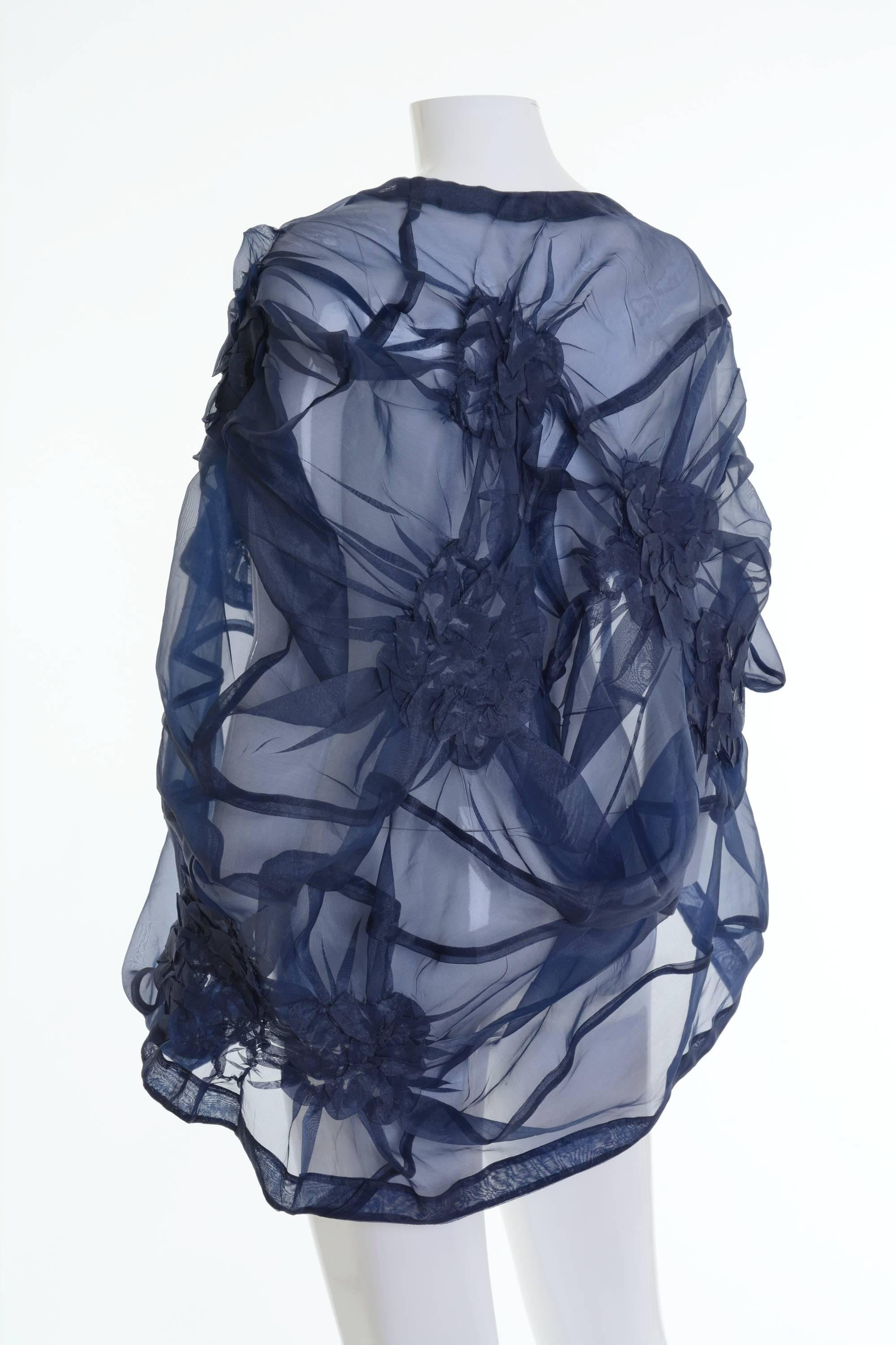 This gorgeous Comme des Garcons cape is in a blue sheer curled and draped fabric. 

Excellent condition 

Label: Comme des Garcons 
Fabric: polyester/nylon
Color: blue

Measurement:
Estimated One Size 
Total length 29 inch