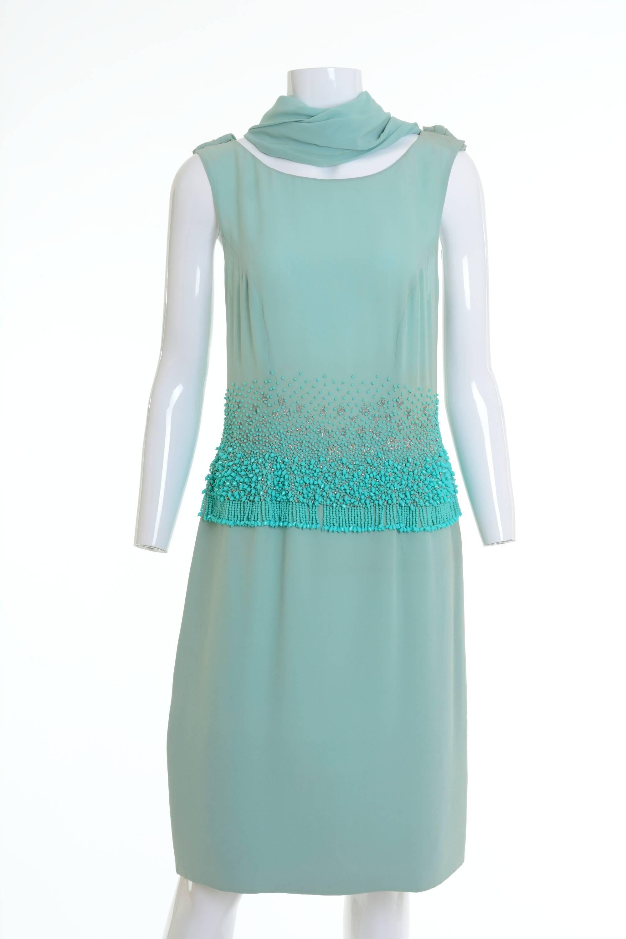 This glamorous and sexy 1950s italian tailored cocktail dress is in fabulous mint green crepe fabric with amazing embroidered glass beadeds details. It has draped back stole detail, side zip closure and hooks and is fully lined. 

Good vintage