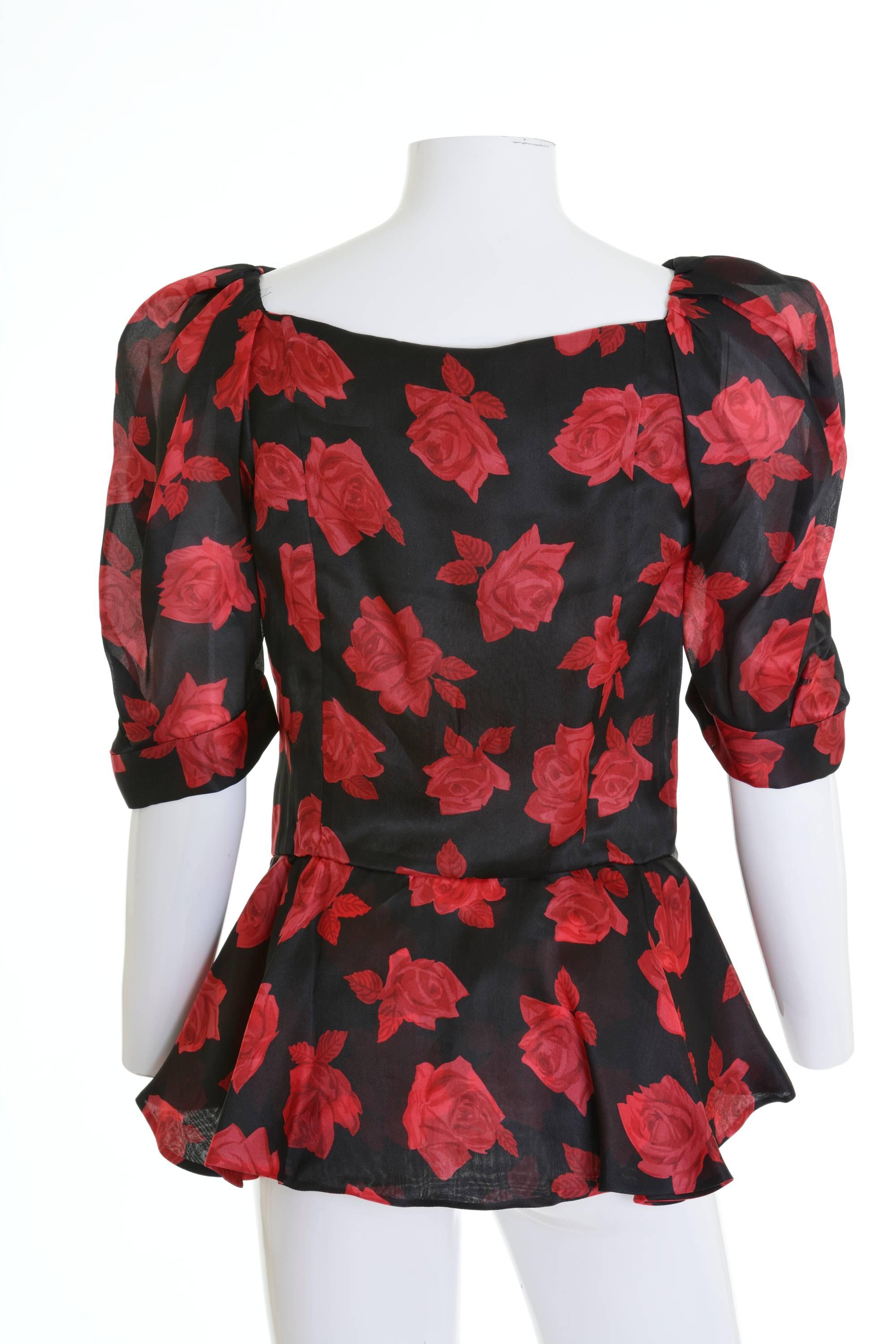 This gorgeous and iconic Yves Saint Laurent 1980s blouse shirt is in a black and red roses print silk fabric. It has boning bodice, peplum line, puffed sleeves and stones buttons closure.

Excellent vintage condition

Label: Yves Saint Laurent Rive