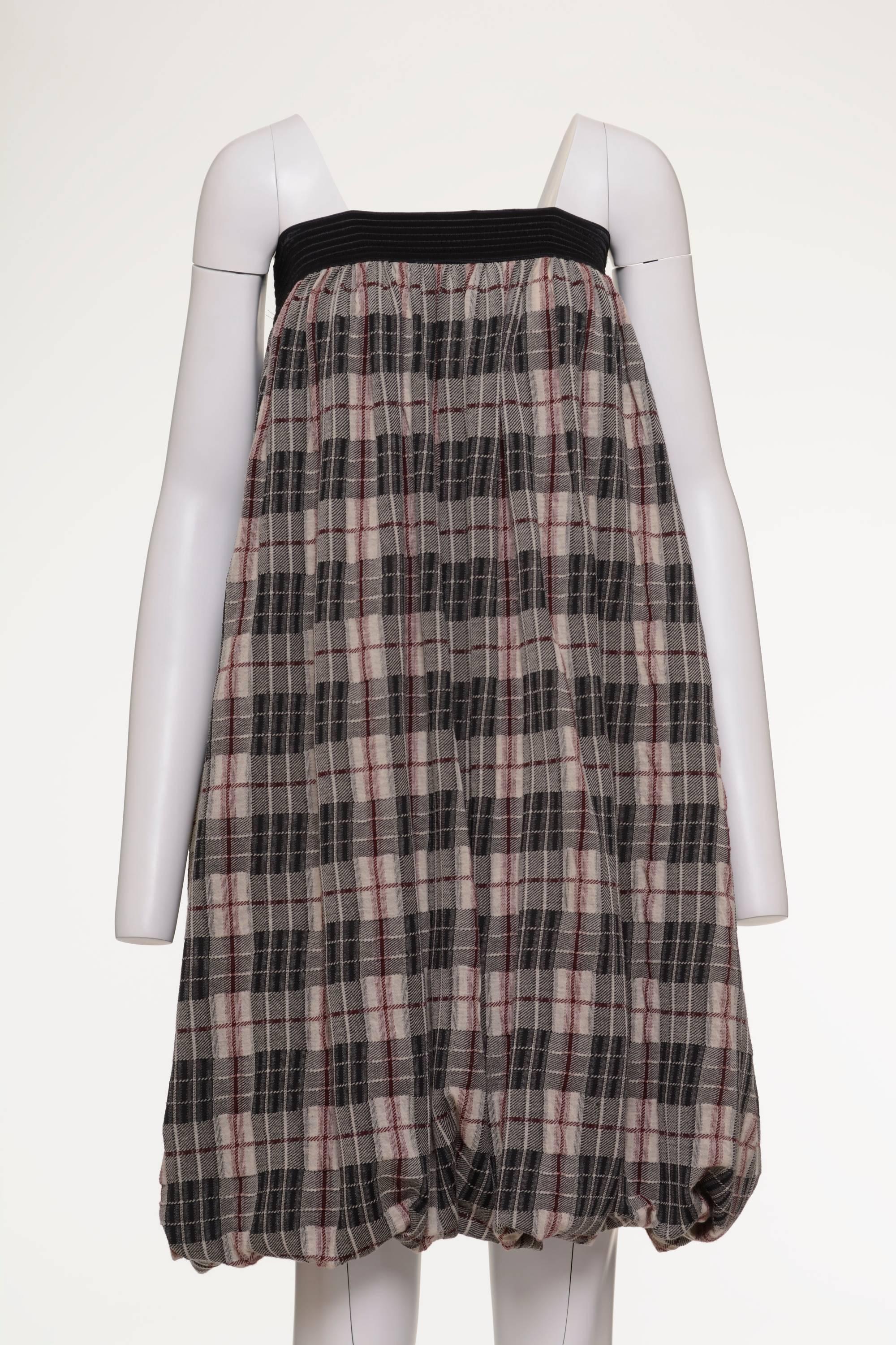 This amazing 1990s Jean Paul Gaultier dress is made with a black and gray tartan print cotton fabric. It's an incredible multimode dress, it can be worn as a long dress, short dress or long skirt. It has black elasticated waist and elasticated hem.