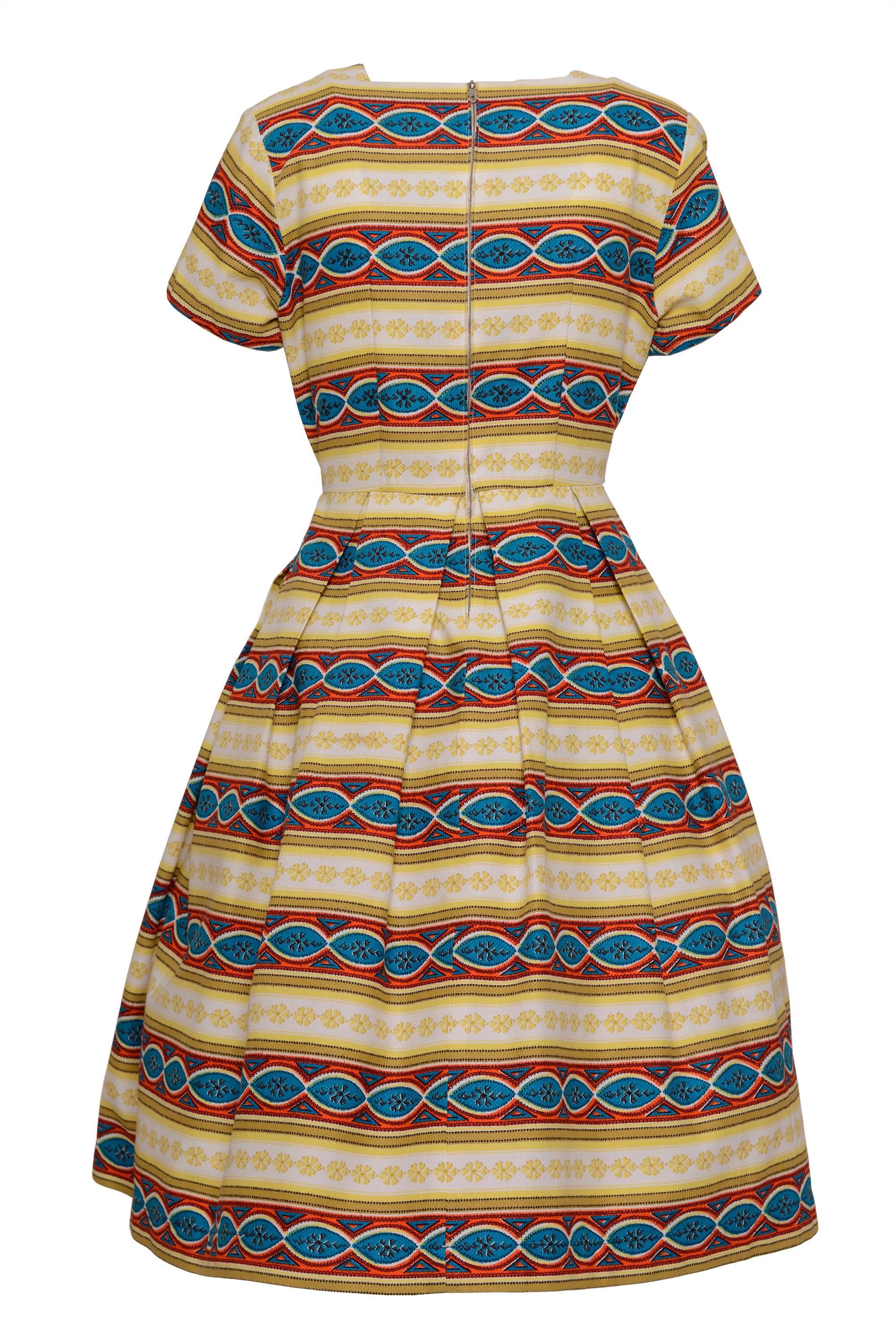 This lovely1950s dress is in cotton pique fabric with a tapestry painted textile. It has back zip closure.

Excellent Vintage Condition 

Label: Unknown 
Fabric: Cotton
Colour: Yellow, Red, Green,Blue, Orange and White 

Measurements:
Estimated size