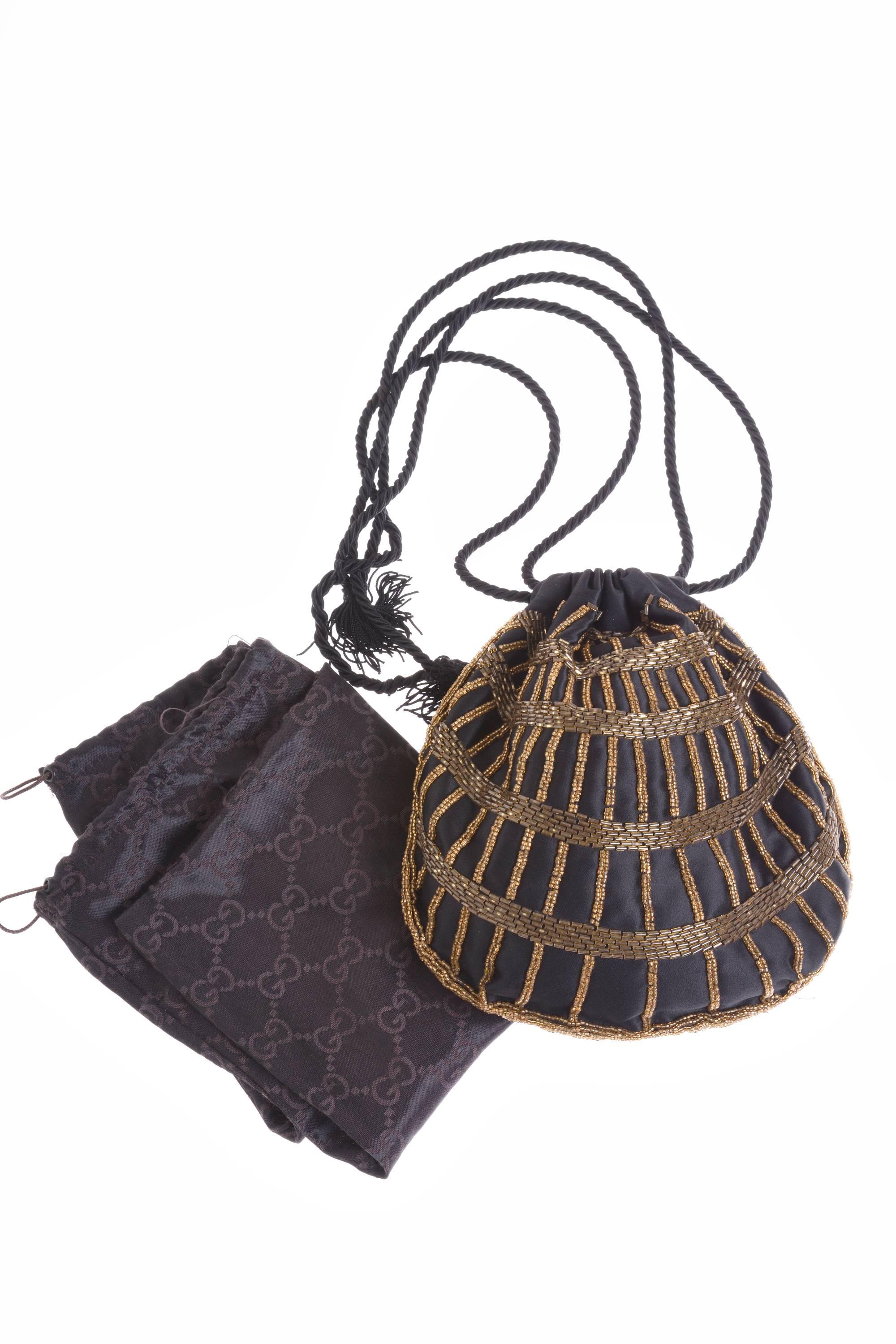 This stunning 1920s style Gucci drawstring bucket bag is in silk satin fabric with bronze beadeds embroidered details. It has satin lined and silk cord drawstring with tassels. It's included the logo dusty bag.
It is the must-have for a Fashion