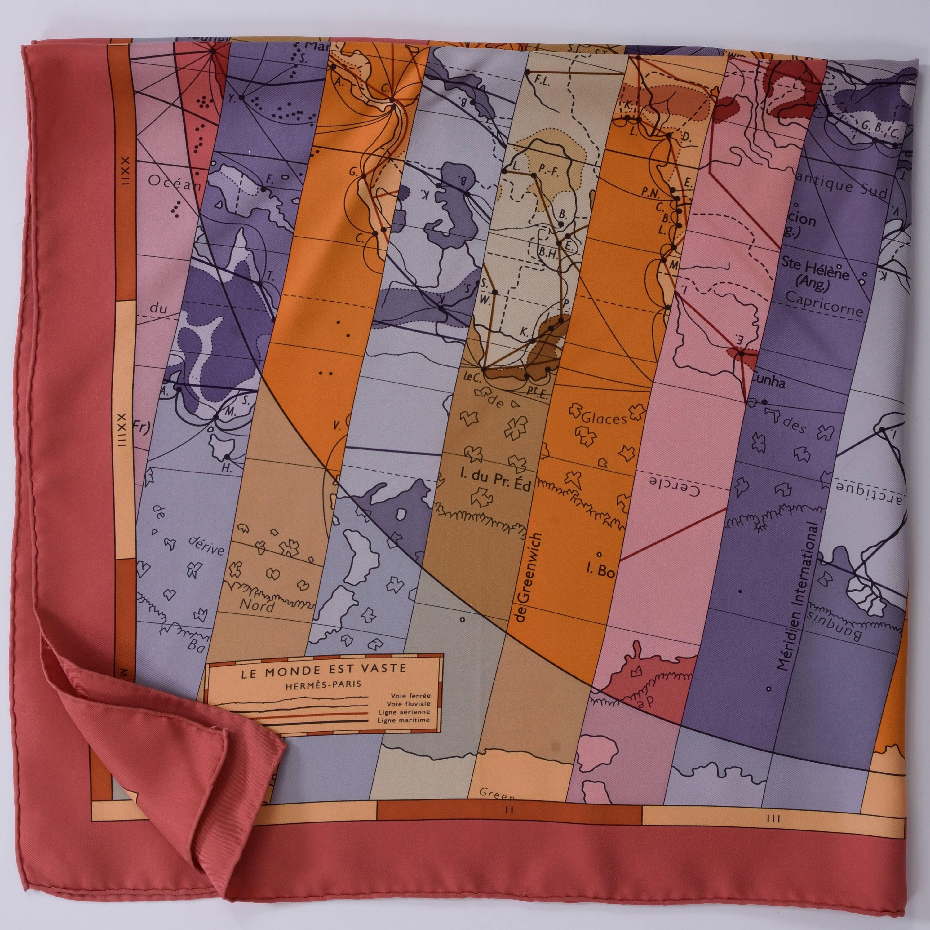This authentic Hermès Scarf is 100% silk and has gray, purple and coral background with geography motif, with hand-rolled edging. 

Excellent condition 

Design by Cyrille Diatkine in 2009  -Made in France-

MEASUREMENTS:
35 x 35 inches