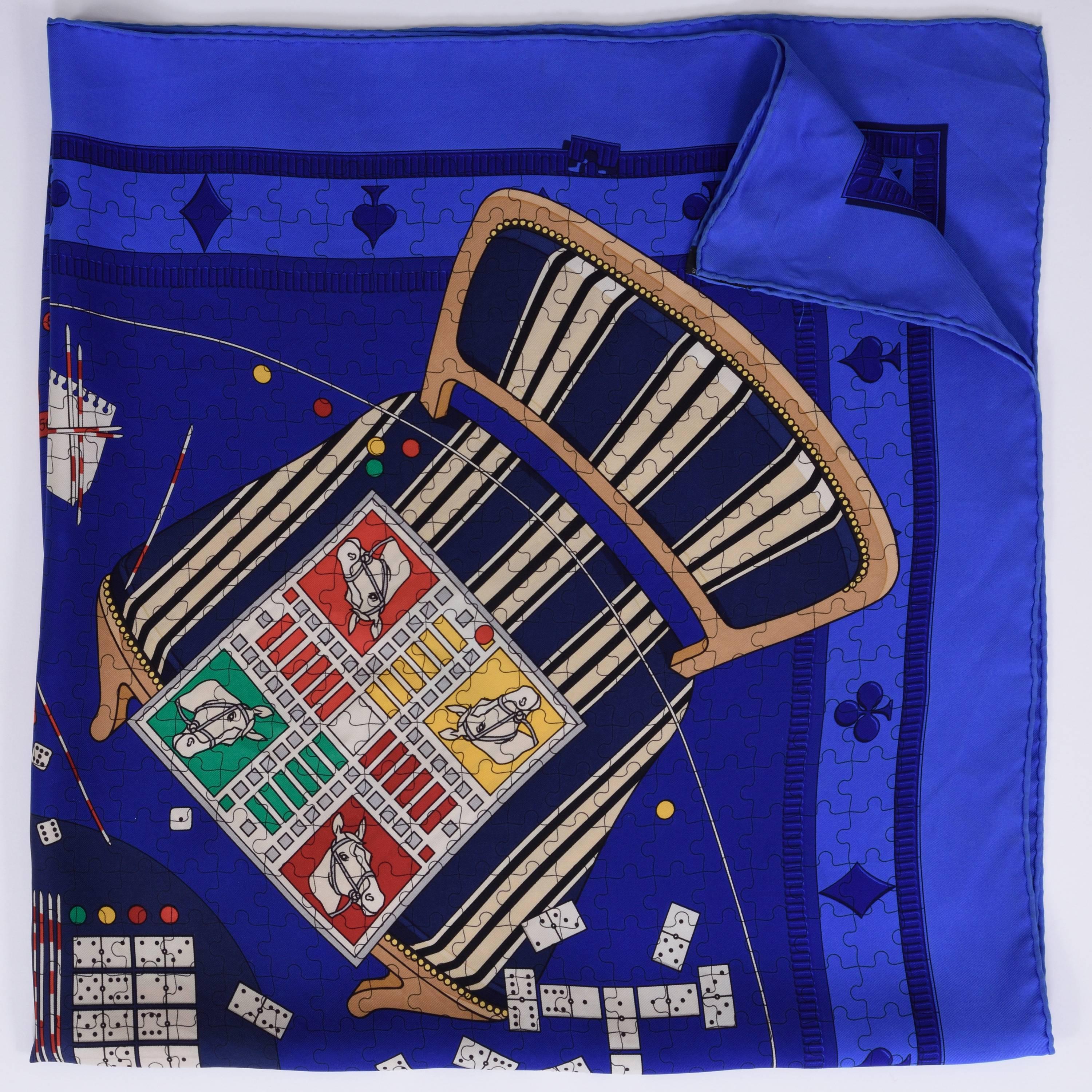 This authentic Hermès Scarf is 100% silk and has blue background with casino play motif, with hand-rolled edging. 

Excellent condition 

Design by Karen Petrossian in 2005  -Made in France-

MEASUREMENTS:
35 x 35 inches