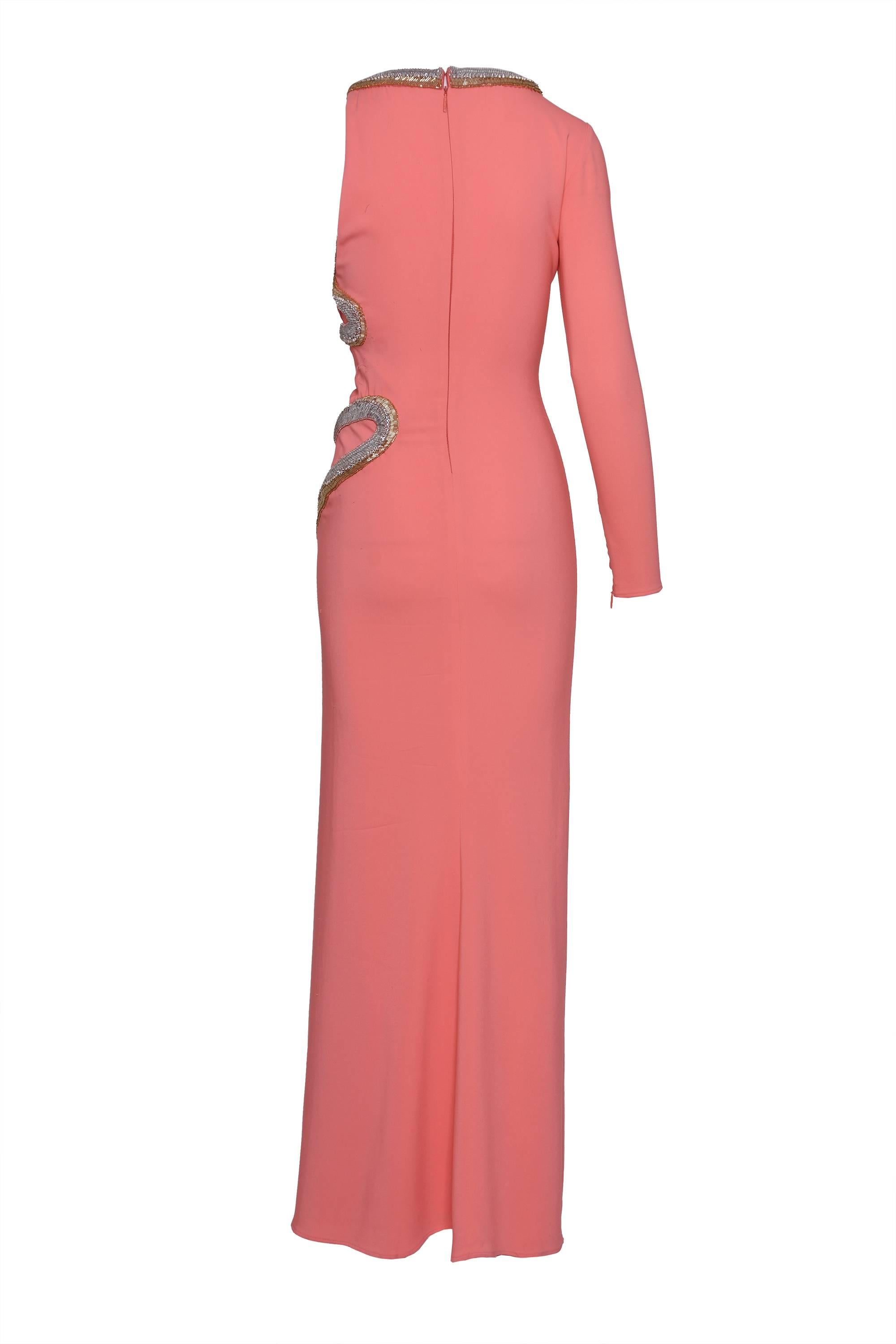 Roberto Cavalli Long Dress in pink salmon with snake embroidery Roberto Cavalli slinky knit gown.
Two-tone beaded snake wraps around neck and falls down side of dress, round neckline, one long sleeve and one minimally covered left shoulder, rightly