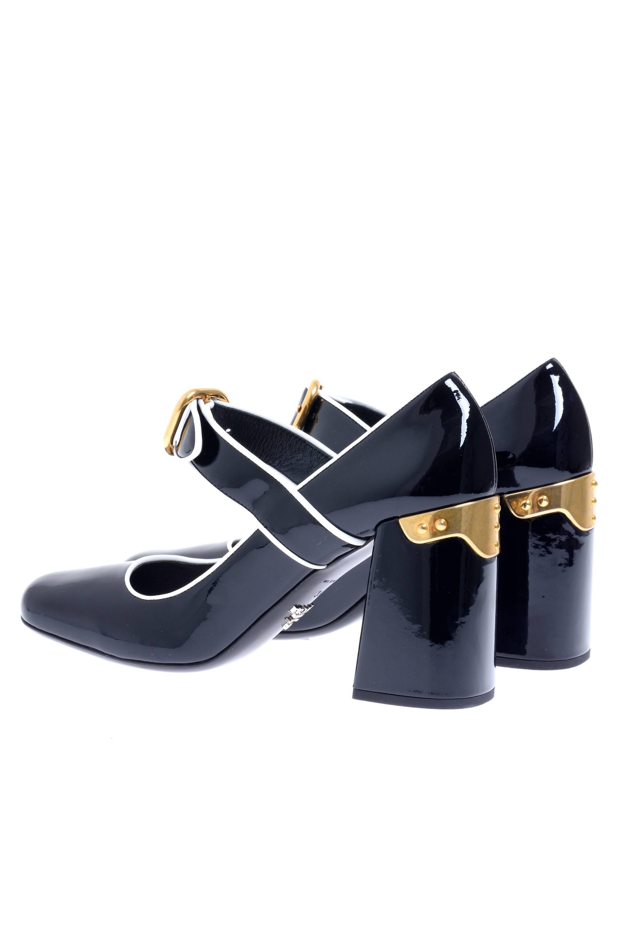 PRADA black glossy patent leather is set off by white piping on this chic mary jane pump, while the square toe,  and chunky heel keep the look ultra-contemporary, a decoration in metal gold in the hell and adjustable strap with buckle