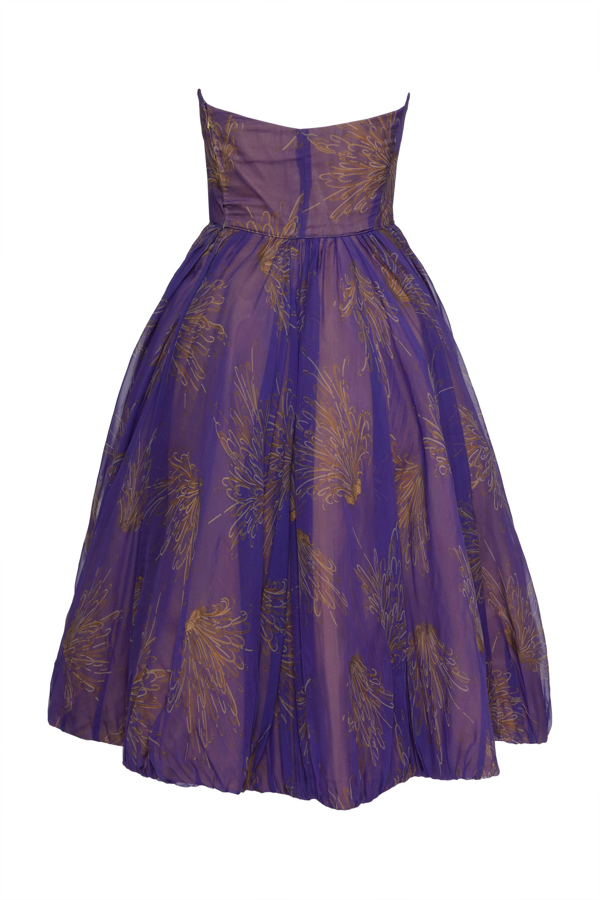 This stunning 1950s strapless dress is in purple organdy silk fabric with abstract floral print and has mustard yellow silk satin bows details. It has full circle skirt and side zip closure. It's fully lined and has crinoline petticoat.

Good