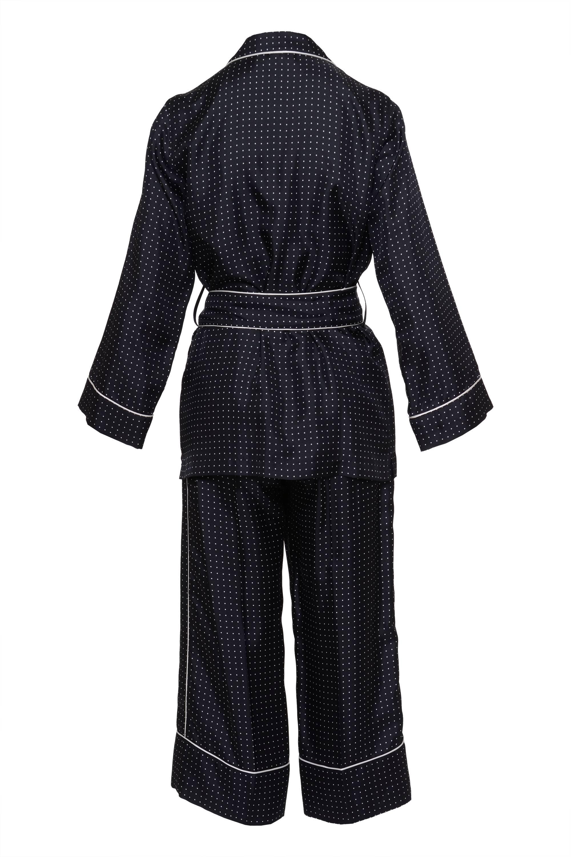 This Black and White polka dot pajamas set by DOLCE and GABBANA has a belt, button closure, 3 frontal U-line pockets with a decorative white line,  Clover collar and long sleeves. The pants have a straight silhouette, 2 frontal slashed side pockets